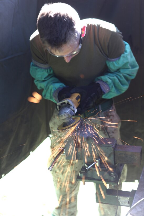Pfc. Caleb H. Johnson, a machinist with 2nd Maintenance Battalion, 2nd Marine Logistics Group, grinds a piece of metal during a training exercise aboard Camp Lejeune, N.C., Sept. 11, 2012.  The Marines set up an Intermediate Maintenance Activity facility, which is a huge garage that provides the tools needed to repair almost any piece of gear Marines use.