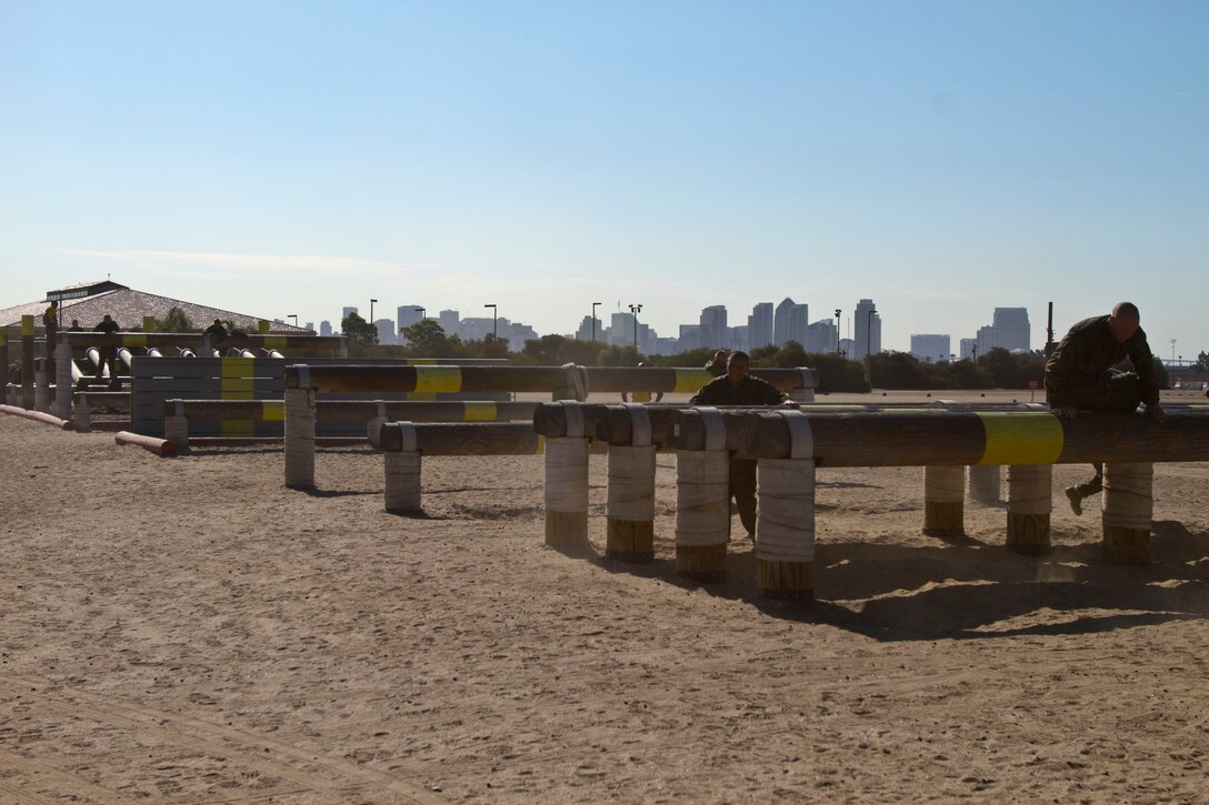 Recruits of Company F, 2nd Recruit Training Battlion, climb over logs during the obstacle course aboard Marine Corps Recruit Depot San Diego Sept. 7. After completing the course, recruits were then instructed to perform combat carries from beginning to end using the fireman's carry and the buddy drag.