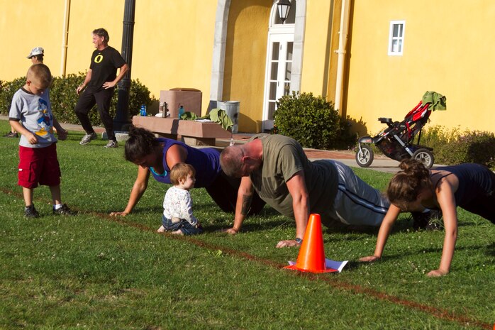The Zimmerman's execute push-ups during a circuit course in preparation for the BootCamp Challenge aboard Marine Corps Recruit Depot San Diego Sept. 6. "It's a great family activity," said Edward Zimmerman, a particpant in the training. "Our whole family comes out here and we have a lot of fun doing it together."