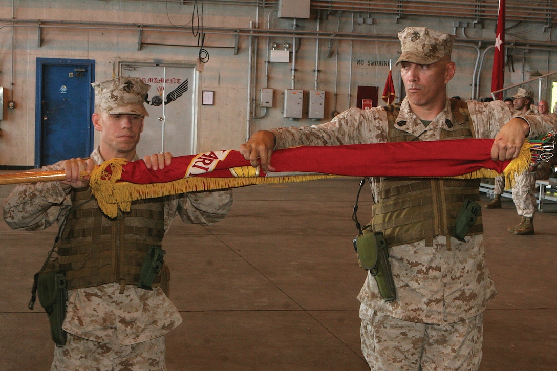 Lt. Col. William L. DePue Jr. and Sgt. Maj. Russell A. Strack case the colors of Marine Medium Helicopter Squadron 265 during a ceremony to redesignate the unit as Marine Medium Tiltrotor Squadron 265 at Marine Corps Air Station Futenma Sept. 7. DePue is the commanding officer of VMM-265, Marine Aircraft Group 36, 1st Marine Aircraft Wing, III Marine Expeditionary Force. Strack is the sergeant major of the squadron. 