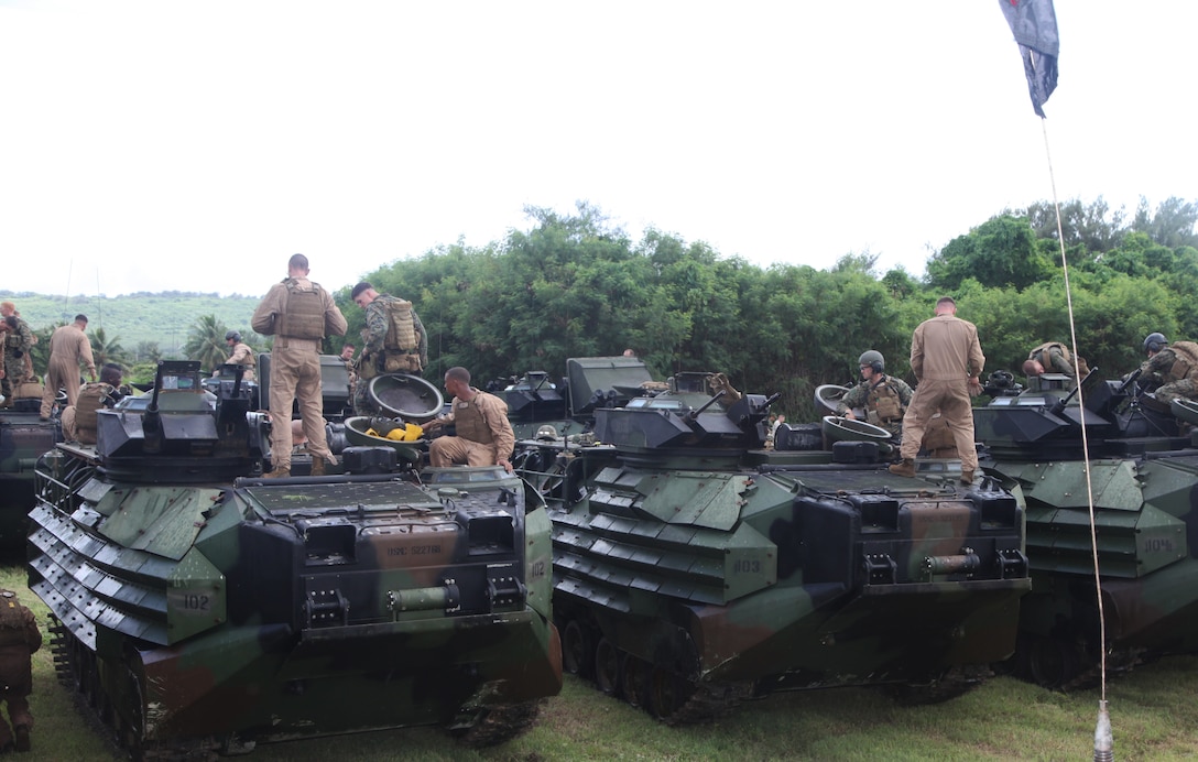 Amphibious assault vehicles with Marines and sailors of Company E., Battalion Landing Team 2nd Battalion, 1st Marine Regiment, 31st Marine Expeditionary Unit, rally in preparation for the assault and seizure of a notional enemy airfield here, Sept. 12-14. The three-day training evolution was the beginning of the 31st MEU's certification exercise, a series of notional operations throughout the Mariana Islands designed to reinforce the Marines' skills and tactics. The airfield seizure exercise was the largest U.S. operation on the island of Tinian since its use as a strategic airfield during World War II. The 31st MEU is the only continuously forward-deployed MEU and is the Marine Corps' force in readiness in the Asia-Pacific region.