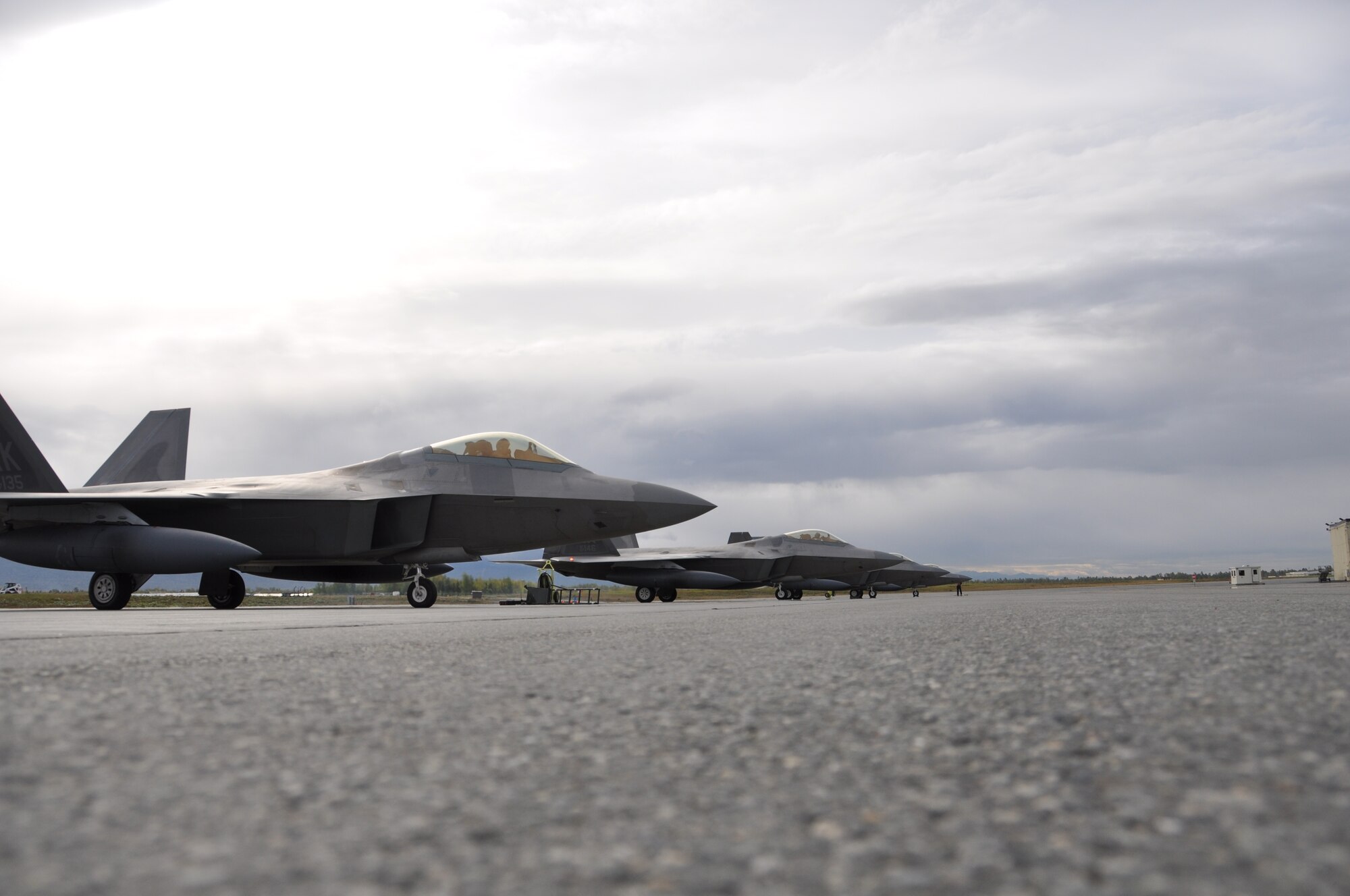 F-22 fighter jets from Joint Base Elmendorf-Richardson line up ready for
flight. The F-22s, assigned to the 3rd Wing, are deployed to Anderson Air
Force Base, Guam in support Pacific Air Forces Theater Security Package
deployments. (U.S. Air Force Photo/Tech. Sgt. Dana Rosso)
  
