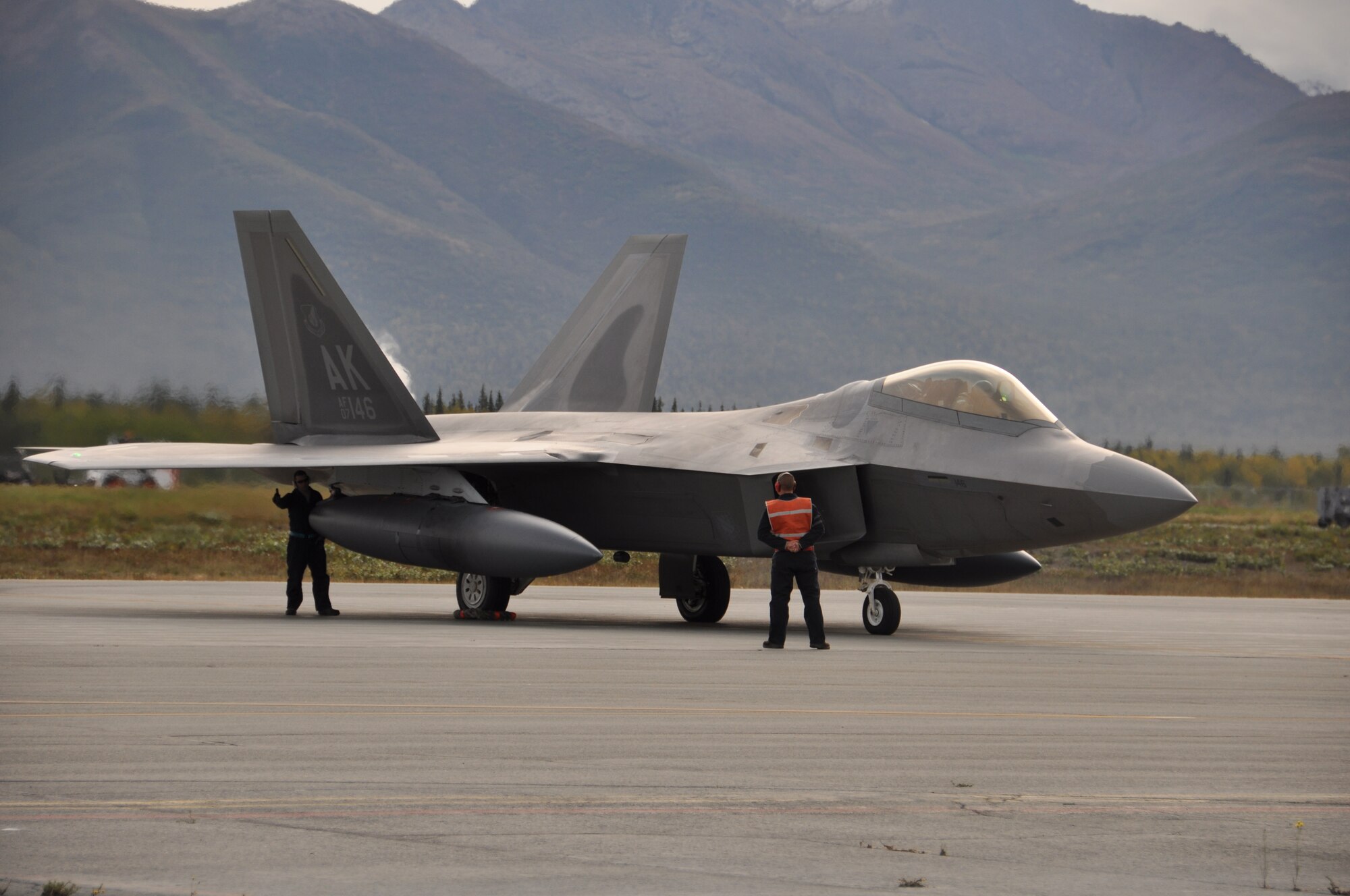 Tech. Sgts. Mark Ling and Andrew Eichorst, dedicated F-22 crew chiefs from
the 477th Aircraft Maintenance Squadron, perform final check on the F-22s
prior to flight. (U.S. Air Force Photo/Tech. Sgt. Dana Rosso)
  
