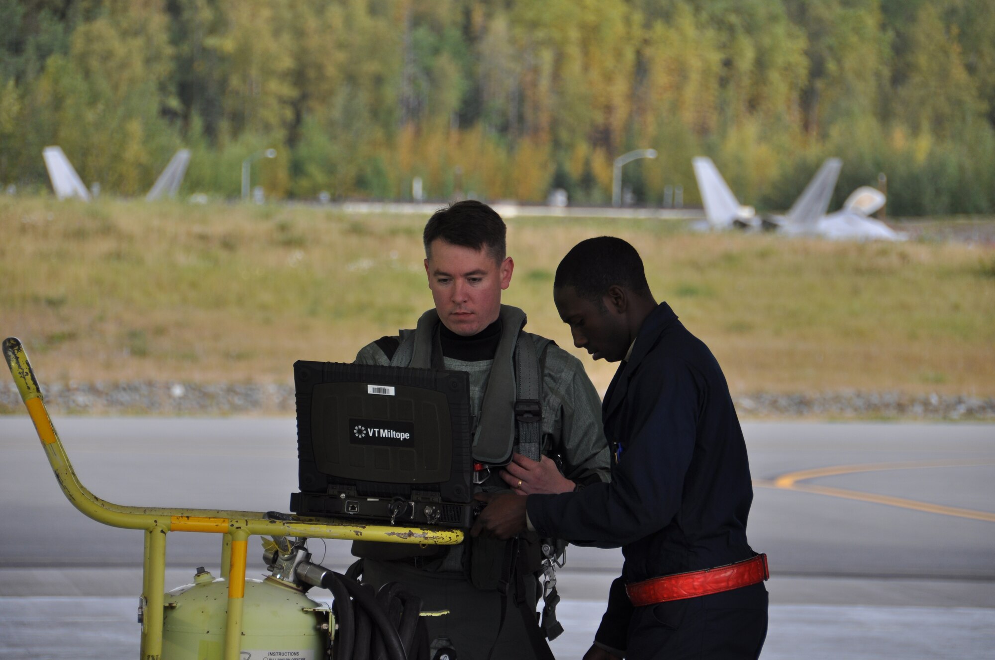 Lt. Col. Nicholas Reed, 90th FS commander, reviews the aircraft forms with
Senior Airman Stephen Teamer, 3rd Aircraft Maintenance Squadron F-22 crew
chief, prior to departing JBER on his way to Andersen Air Force Base, Guam. 
This marks the first time since 2011 F-22's from the 3rd Wing have deployed
to the Pacific Theater of Operations.  (U.S. Air Force Photo/Tech. Sgt. Dana
Rosso)
