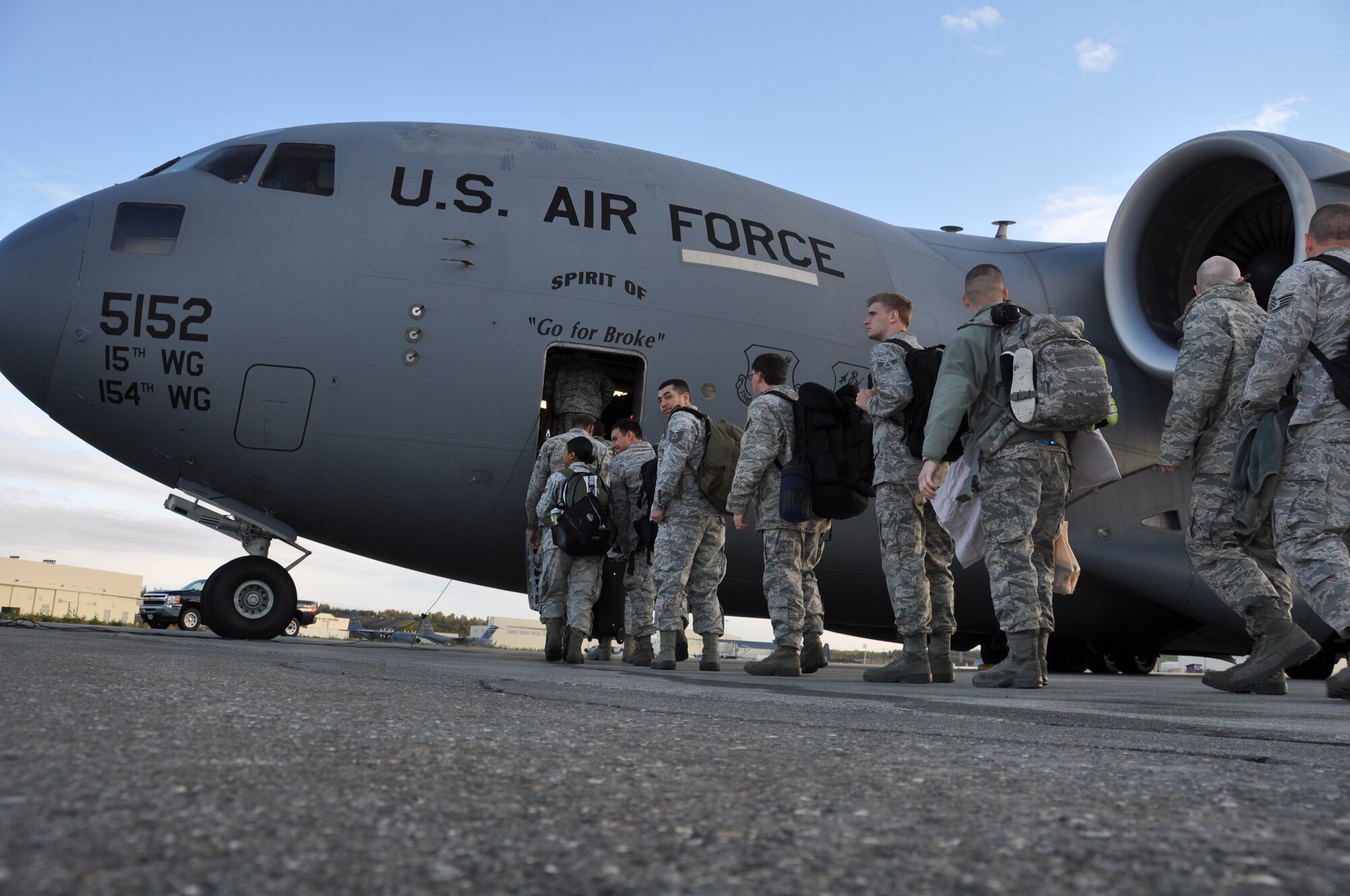 Active duty and Reserve maintenance and support personnel from the 3rd Wing
and 477th Fighter Group board a C-17 Globemaster III on their way to
Andersen Air Force Base, Guam.This marks the first time since 2011 F-22's from the 3rd Wing have deployed to the Pacific Theater of Operations.  (U.S. Air Force Photo/Tech. Sgt. Dana Rosso)
