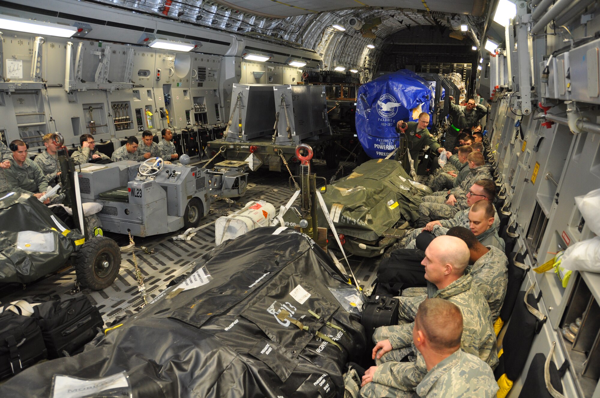 Active duty and Reserve maintenance and support personnel from the 3rd Wing
and 477th Fighter Group wait to take off on a C-17 Globemaster III on their
way to Andersen Air Force Base, Guam. This marks the first time since 2011 F-22's from the 3rd Wing have deployed to the Pacific Theater of Operations.  (U.S. Air Force Photo/Tech.Sgt. Dana Rosso)
