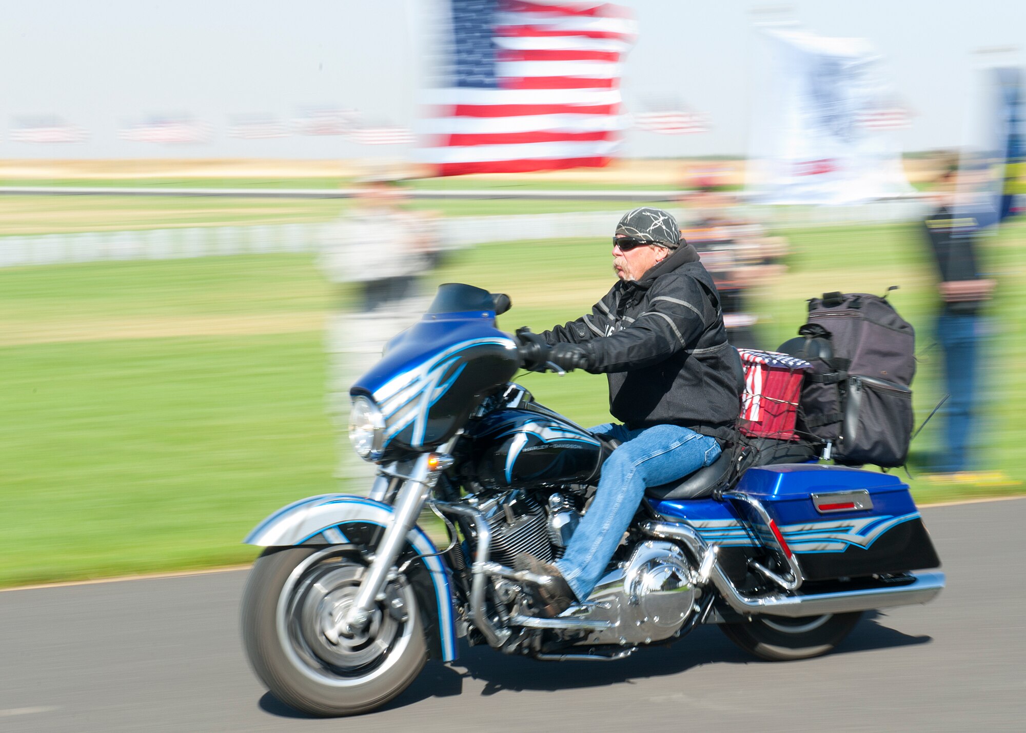 A member of the Patriot Guard Riders escorts the remains of 20 veterans and one spouse during an honor service for the Missing in America Project at Washington State Veterans Cemetery in Medical Lake, Wash., Sept. 10, 2012. The purpose of the MIAP is to locate, identify and inter the unclaimed cremated remains of American veterans through the joint efforts of private, state and federal organizations to provide honor and respect to those who have served this country by securing a final resting place for these forgotten heroes. (U.S. Air Force photo by Staff Sgt. Michael Means)