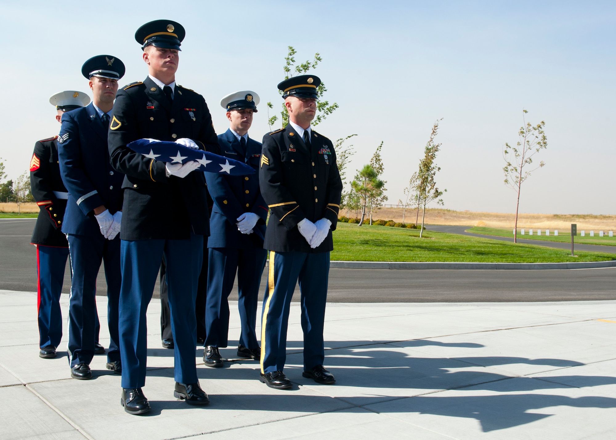 Members of the Joint Service Honor Guard perform military honors for the remains of 20 veterans and one spouse for the Missing in America Project at Washington State Veterans Cemetery in Medical Lake, Wash., Sept. 10, 2012. The honor service included a flag folding, rifle salute and the playing of taps. (U.S. Air Force photo by Staff Sgt. Michael Means)