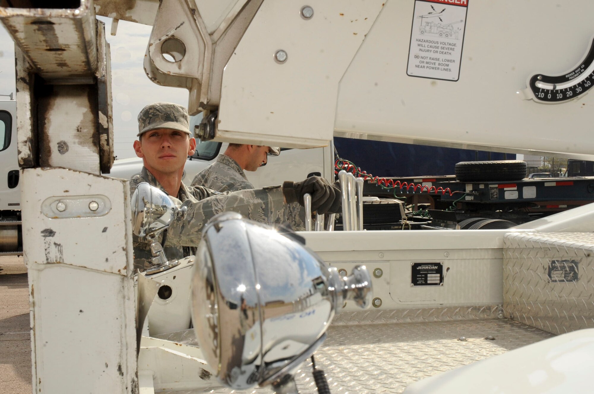 Airman First Class Joseph Bunton, 28th Logistics Readiness Squadron vehicle operator, uses the operating controls to lower a forklift during training to the ground at the vehicle maintenance facility at Ellsworth Air Force Base, S.D., Sept. 11, 2012. Bunton is being trained to properly transport heavy machinery and vehicles to prevent possible injuries and damages. (U.S. Air Force photo by Airman 1st Class Anania Tekurio/Released)