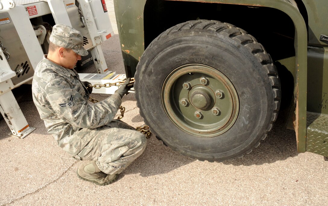 Airman First Class Dion Sosa, 28th Logistics Readiness Squadron vehicle operator, releases the chains off a forklift during training at the vehicle maintenance facility at Ellsworth Air Force Base, S.D., Sept. 11, 2012. Sosa is in training to learn how to safely transport heavy machinery to avoid equipment damage and injury to personnel. (U.S. Air Force photo by Airman 1st Class Anania Tekurio/Released) 