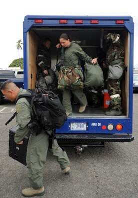 Exercise participants exit a "bread truck" during an Operational Readiness Exercise scenario on the 15th Wing flightline Sept. 13 at Joint Base Pearl Harbor-Hickam, Hawaii. The exercise's participants were tested on their ability to properly react to a broad range of scenarios and environmental conditions. (U.S. Air Force photo by Staff Sgt. Nathan Allen) 