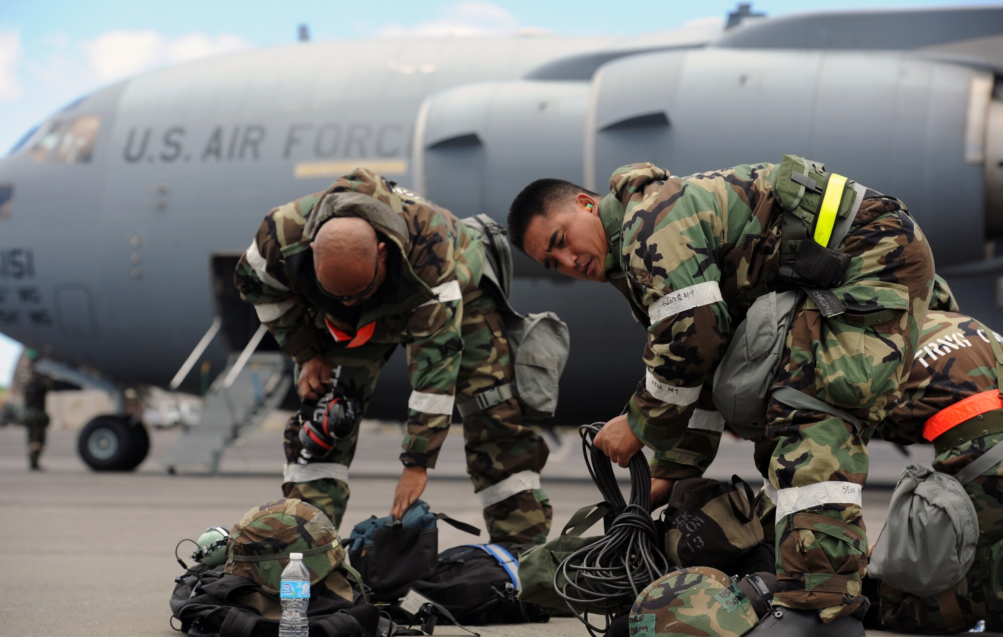 Staff Sgt. Darrin Kahala, 154th Aircraft Maintenance Squadron KC-135 Stratotanker aircraft mechanic (left), and Senior Airman Brandon Solidum, 154th Aircraft Maintenance Squadron crew chief, pack equipment during an Operational Readiness Exercise scenario on the 15th Wing flightline Sept. 13 at Joint Base Pearl Harbor-Hickam, Hawaii. The exercise's participants were tested on their ability to properly react to a broad range of scenarios and environmental conditions. (U.S. Air Force photo by Staff Sgt. Nathan Allen) 