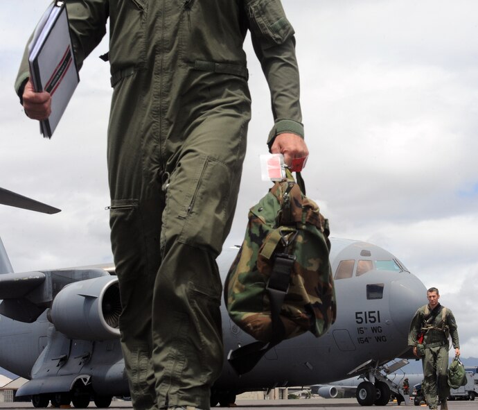 Exercise participants exit a C-17 Globemaster III during an Operational Readiness Exercise scenario on the 15th Wing flightline Sept. 12 at Joint Base Pearl Harbor-Hickam, Hawaii. The exercise's participants were tested on their ability to properly react to a broad range of scenarios and environmental conditions. (U.S. Air Force photo by Staff Sgt. Nathan Allen) 