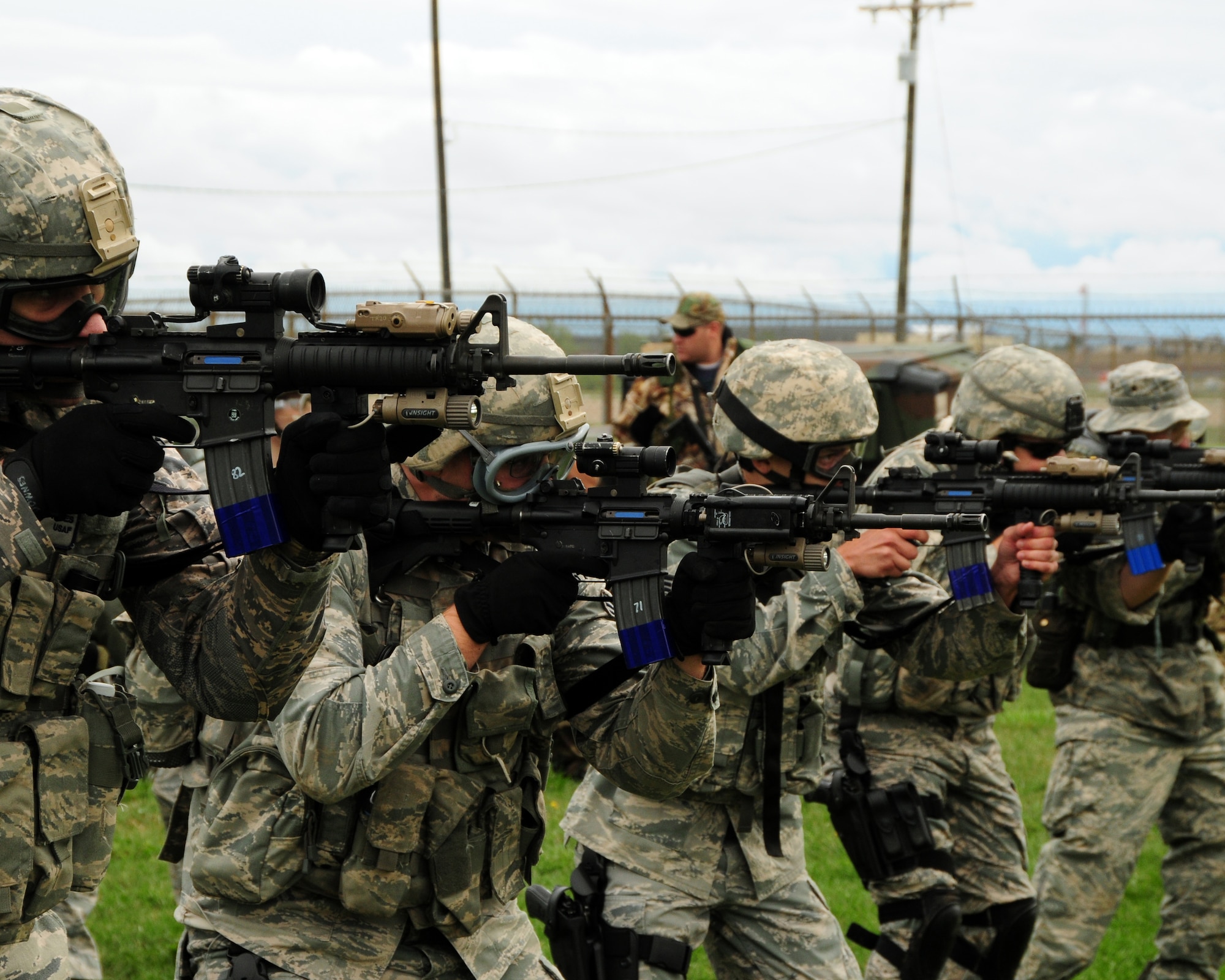 914th Security Force Squadron members line up and fire simunations at stationary targets prior to heading out and testing their skills against opposition forces during a recent exercise at the Niagara Falls Air Reserve Station, NY on September 8, 2012. The exercise also involved members from the 914th Logistics Readiness Squadron. (US Air Force photo by Peter Borys)