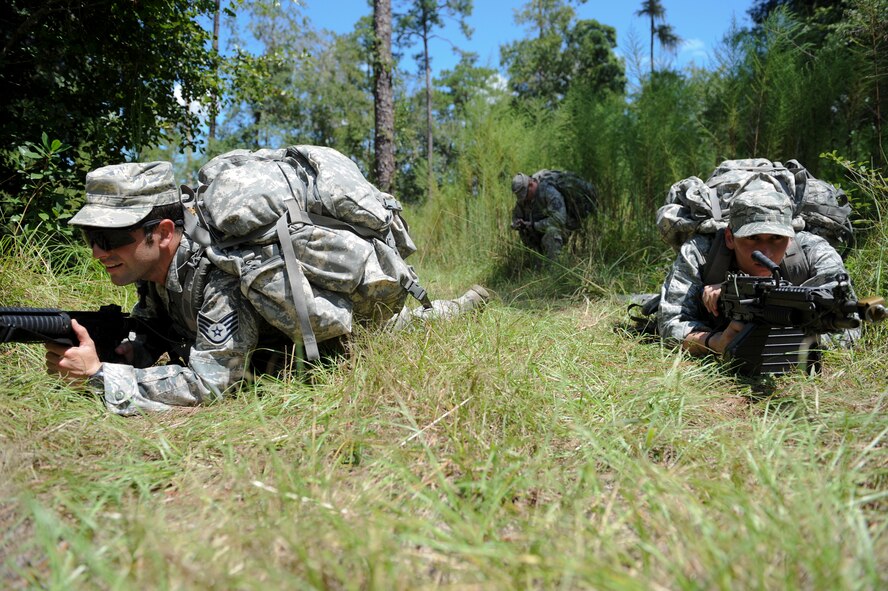 Two Airmen from the 820th Base Defense Group cover their squad as they take out enemy forces during Pre-Ranger Focus Training Course at Moody Air Force Base, Ga., Sept. 7, 2012. Airmen who participated in the training were evaluated on their physical fitness and ability to lead a patrol under harsh living conditions. (U.S. Air Force photo by Senior Airman Douglas Ellis/Released)
