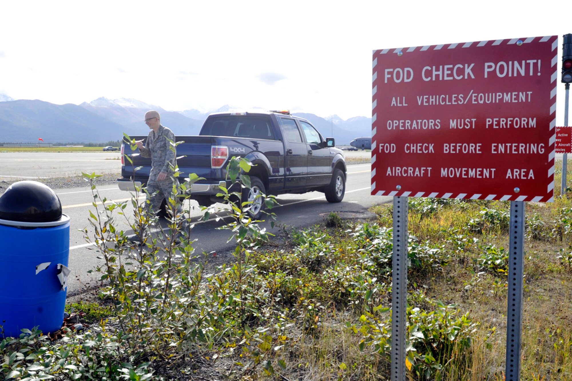 JOINT BASE ELMENDORF-RICHARDSON, Alaska -- Airman 1st Class Patrick Yohn, 3rd Operations Support Squadron, Airfield Management, performs a routine Foreign Object Debris check upon entering the flight line Sept. 4. A FOD check is done to prevent any objects from possibly damaging incoming taxiing aircraft. (U.S. Air Force photo/ Airman Ty-Rico Lea)