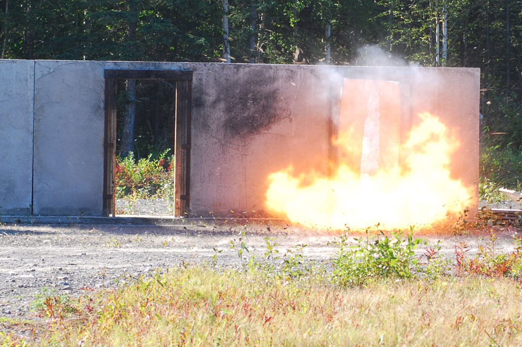 An explosion breaches a door at the live fire breach range facility on JBER. Paratroopers with A Company, 425th Brigade Special Troops Battalion, conducted the training to maintain proficiency as combat engineers. (U.S. Army photos/Staff Sgt. Jeffrey Smith)