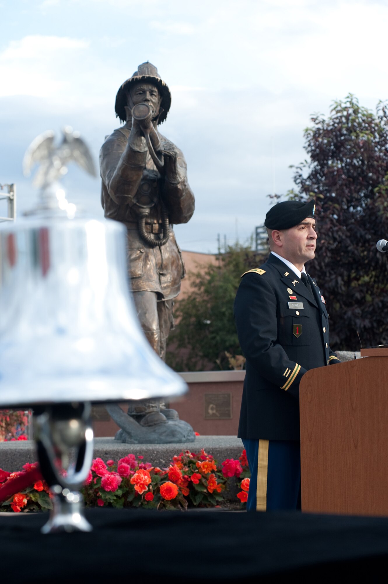Army Maj. Joshua Camara speaks during the 2012 Alaska Fallen Firefighter Memorial Ceremony and Sept. 11 Remembrance in Anchorage. The memorial, located next to Fire Station One, was hosted to remember firefighters who died in Alaska. The walls contain 27 plaques, including four additional names added that day: Army Capt. Francis C. Allen, Pvt. Ralph Kirkbride, Pvt. Frank Hayton and Pvt. Hedley Estabrook. Camara is an Army Public Affairs officer on JBER. (U.S. Air Force photo/Staff Sgt. Robert Barnett)
