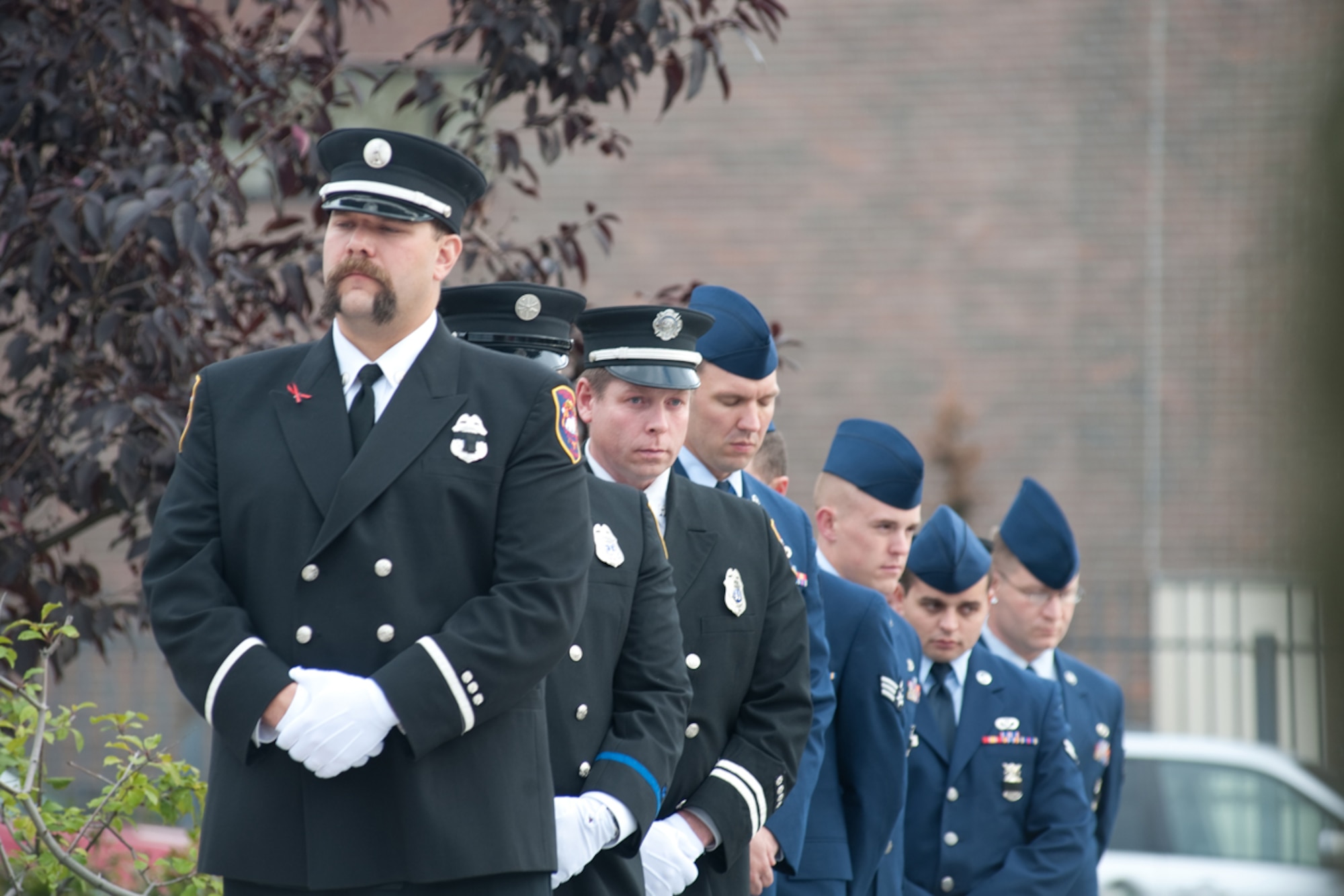 Members of the Anchorage Fire Department and Airmen from JBER pay their respects during the 2012 Alaska Fallen Firefighter Memorial Ceremony and Sept. 11 Remembrance in Anchorage. The memorial, located next to Fire Station One, was hosted to remember firefighters that who in Alaska. The walls contain 27 plaques, including four additional names added that day: Army Capt. Francis C. Allen, Pvt. Ralph Kirkbride, Pvt. Frank Hayton and Pvt. Hedley Estabrook. (U.S. Air Force photo/Staff Sgt. Robert Barnett)