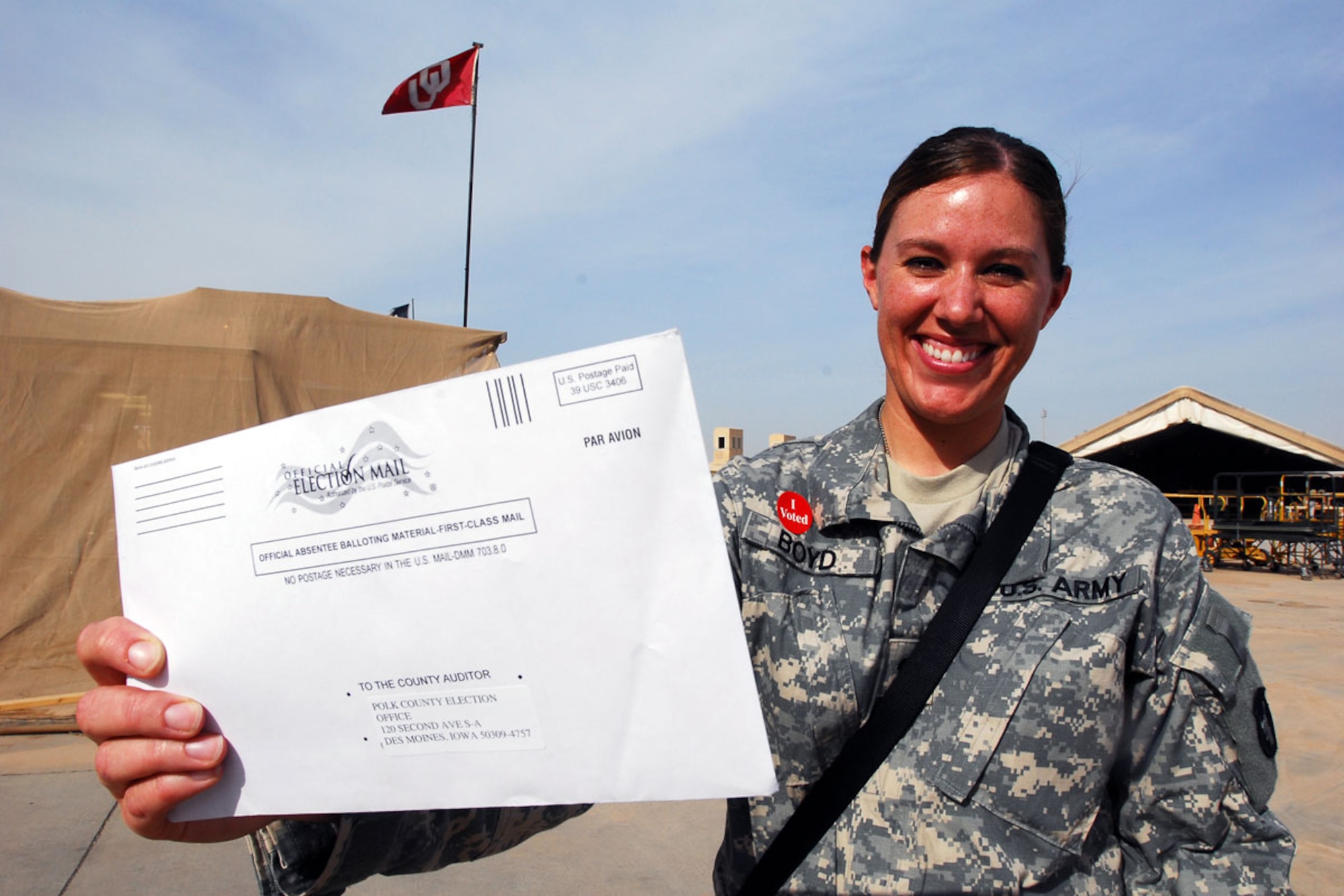 Spc. Andrea Boyd holds up her absentee ballot. (U.S. Army photo/Staff Sgt. Lynette Hoke)