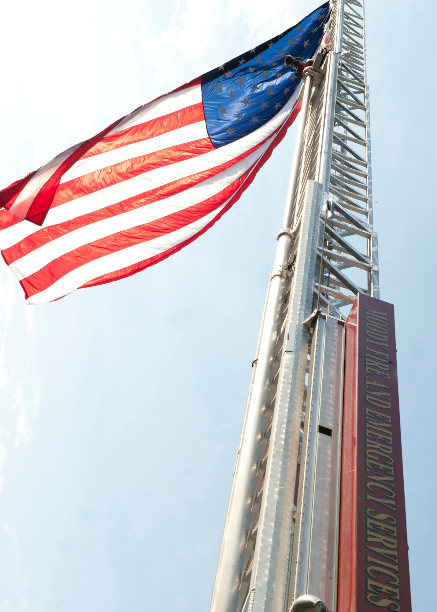 The American flag waves on an aerial ladder at the Moody Fire Department during the 11 year remembrance ceremony for the 9/11 terrorist attacks Sept. 11, 2012, at Moody Air Force Base, Ga. The ceremony was held to honor and pay tribute to the lives of people lost as a result of the attacks. (U.S. Air Force photo by Senior Airman Eileen Meier/Released)