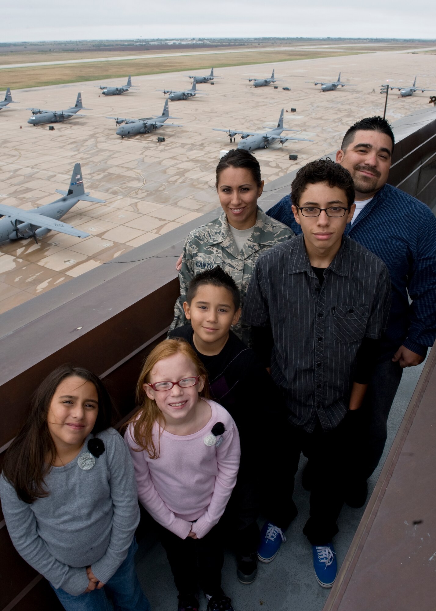 The Cantu family poses atop the control tower Sept. 13, 2012, at Dyess Air Force Base, Texas. Tech. Sgt. Blanca Cantu, 7th Operations Support Squadron, her husband Chris and their four children work together to get through the daily obstacles of having an unconventional military family. (U.S. Air Force photo by Airman 1st Class Peter Thompson/ Released)