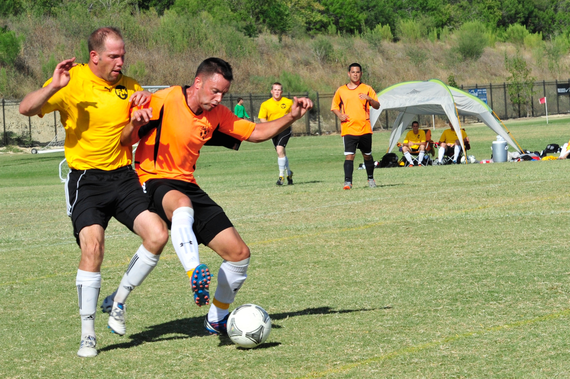 Staff Sgt. Rick Jones, 308th Aircraft Maintenance Unit crew chief, works to advance the ball and gain position to shoot against Kirkland AFB, N.M. The tournament is intended to promote healthy competition between services and bases, but it is also a tool used by the Air Force Soccer team to scout potential recruits for the three-week tryout camp that immediately follows the tournament. Jones submitted a package prior to the tournament and is currently attending the three-week tryout camp in San Antonio.  (U.S. Air Force photo by Staff Sgt. Jaime Ciciora)
