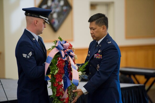 Col. H.B. Brual, 341st Missile Wing commander, right, along with Honor Guard member Senior Airman Malcom Hunter II, 341st Civil Engineer Squadron electrical apprentice, lay a wreath in memory of the nearly 3,000 people whose lives were claimed in the 9/11 terrorist attacks during a remembrance ceremony held on Sept. 11 in the Grizzly Bend.  In conjunction with the laying of the wreath, Team Malmstrom members had a moment of silence in honor of the victims and their families.  (U.S. Air Force photo/Beau Wade)