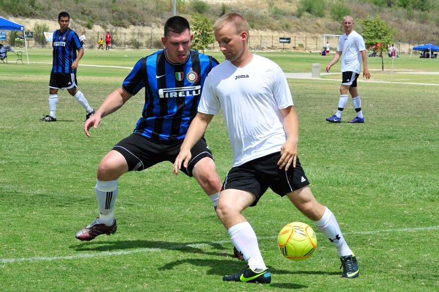 Thomas Edwards IV, 99th Medical Group health services manager, attempts to stop an Offutt AFB forward from advancing on the Falcons goalie during the Defender’s Cup at the Star Soccer Complex in San Antonio.  (U.S. Air Force photo by Staff Sgt. Jaime Ciciora)