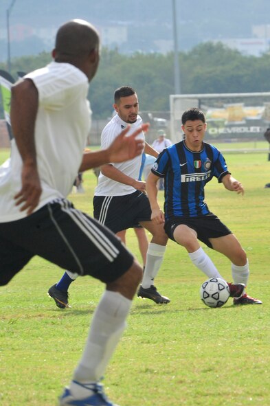 Mauricio Sandoval, an administration clerk for Inspector Instructor Bulk Fuels, Company C, 6th Engineering Support Battalion, 4th Marine Logistics Group based at Luke Air Force Base, maneuvers the ball around defenders from Fort Sam Houston, Texas, during game one for the Falcons in the Defender’s Cup at the Star Soccer Complex in San Antonio, Sept. 1. Sandoval scored four of the Falcon’s six goals during the tournament.  (U.S. Air Force photo by Staff Sgt. Jaime Ciciora)