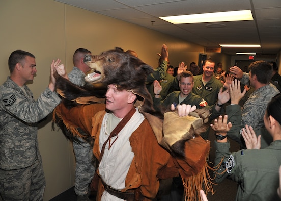 1st Lt. Lee Feldhausen, 341st Operations Support Squadron ICBM instructor combat crew commander, dressed as Roadkill, Wing One’s mascot, leads several Team Malmstrom members competing in this year’s Global Strike Challenge down a hallway as Airmen high five them in support and for good luck on Sept. 11.  Following him is Capt. Ryan Hepler, 341st Operations Support Squadron ICBM combat crew commander, and 2nd Lt. Bryce Acres, 341st Operations Group ICBM deputy combat crew commander, who were both chosen to represent the 10th Missile Squadron.  There were seven sendoff walks this week, which marked the kick off of Malmstrom’s participation in the ICBM operations and maintenance portions of the GSC.  (U.S. Air Force photo/John Turner)