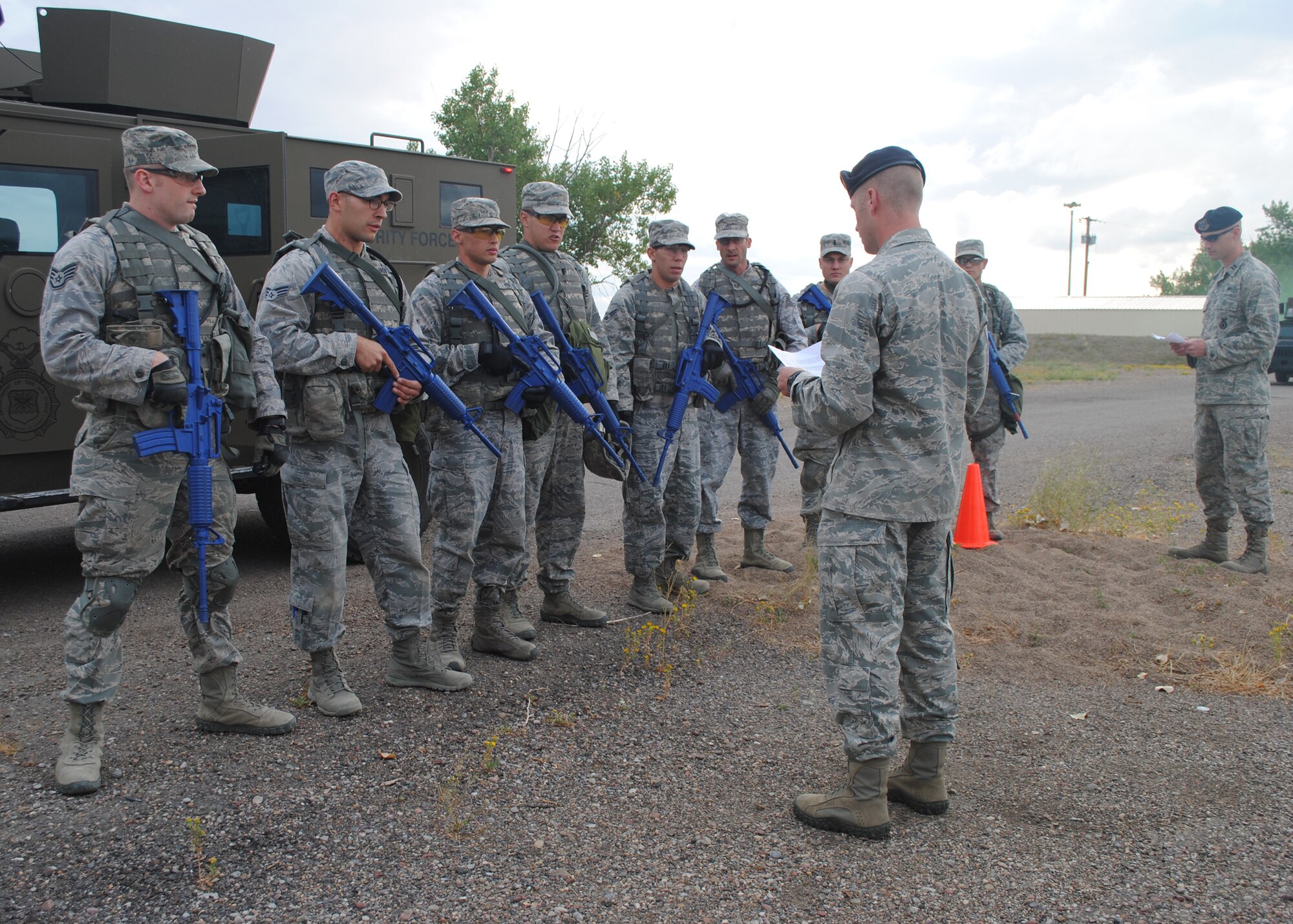 1st Lt. Andrew Stolten, 341st Security Forces Squadron free zone officer in charge and a team trainer, center, reads a mission brief to Malmstrom’s 341st Security Forces Group Global Strike Challenge team competitors during a mental and physical challenge at the Warrior Launch Facility on Sept. 6. Capt. Michael Cheatham, 741st Missile Security Forces Squadron operation officer, far right, and Stolten designed the challenge to prepare the team and simulate the upcoming GSC. (U.S. Air Force photo/Airman 1st Class Katrina Heikkinen)