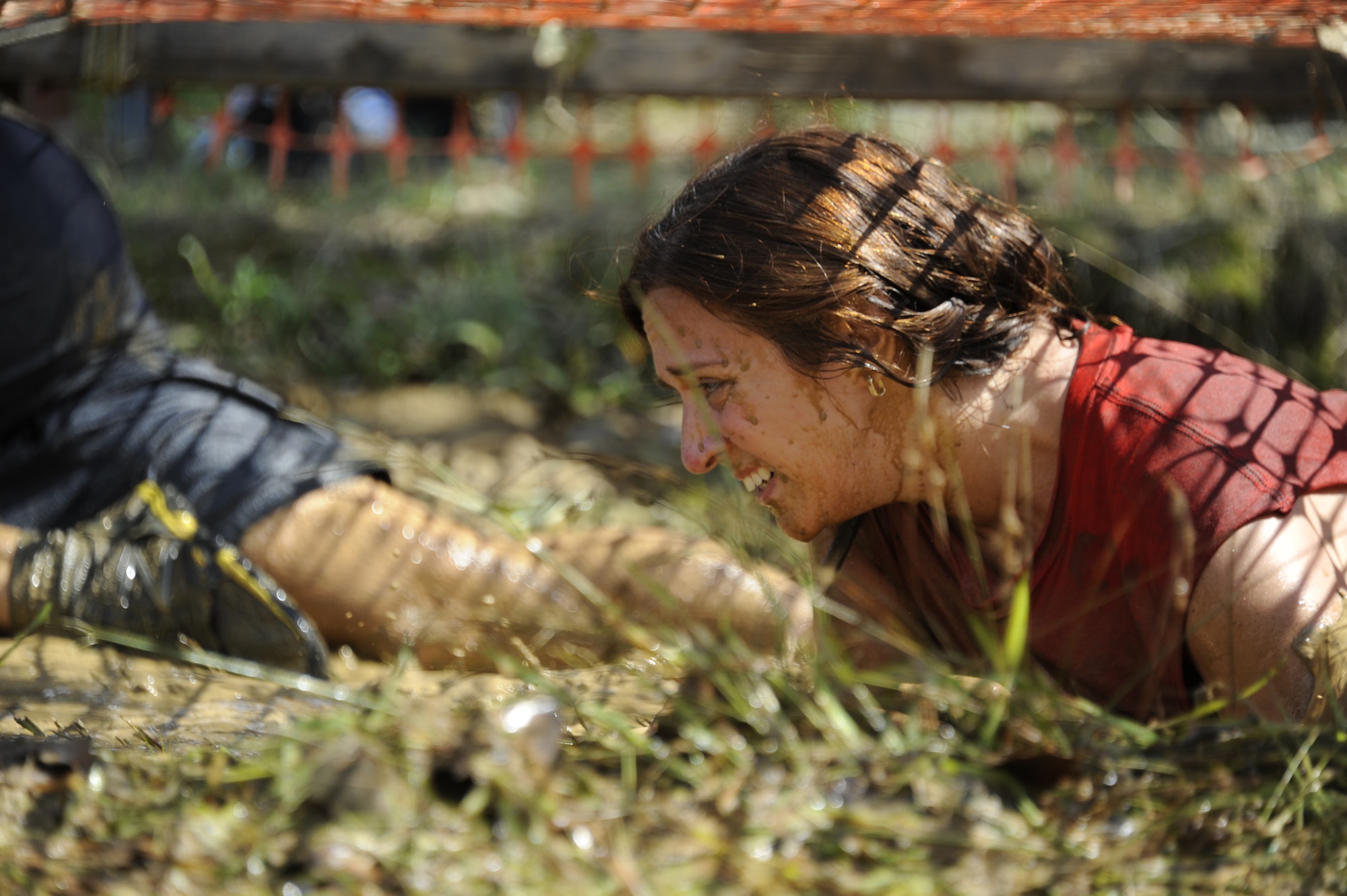 A mud run participant trudges through a mud pit at the “Climb over wall” obstacle Sept. 8 during the Joint Base McGuire-Dix-Lakehurst "Beast of the East" Mud Run here. This was the 23rd and final obstacle of the fifth annual Mud Run. (U.S. Air Force photo by 2nd Lt. David J. Murphy/Released)