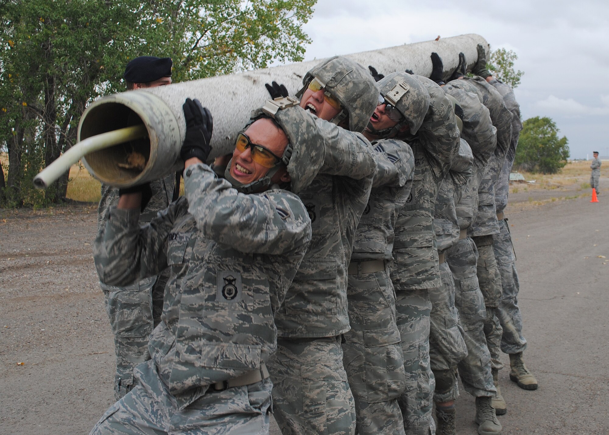 (From left) Airman 1st Class Michael Fenex, 341st Security Forces Squadron response force leader, Senior Airman Collin Kleckley, 341st SFS member, and Senior Airman Brainard Moore, 341st Missile Security Forces Squadron member, lead Malmstrom’s security forces Global Strike Challenge team members as they lift a weighted pole at station five at the Warrior Launch Facility on Sept. 6. The team has spent the past month preparing for the GSC, scheduled for Sept. 24 to 28 at Camp Guernsey, Wyo. (U.S. Air Force photo/Airman 1st Class Katrina Heikkinen)