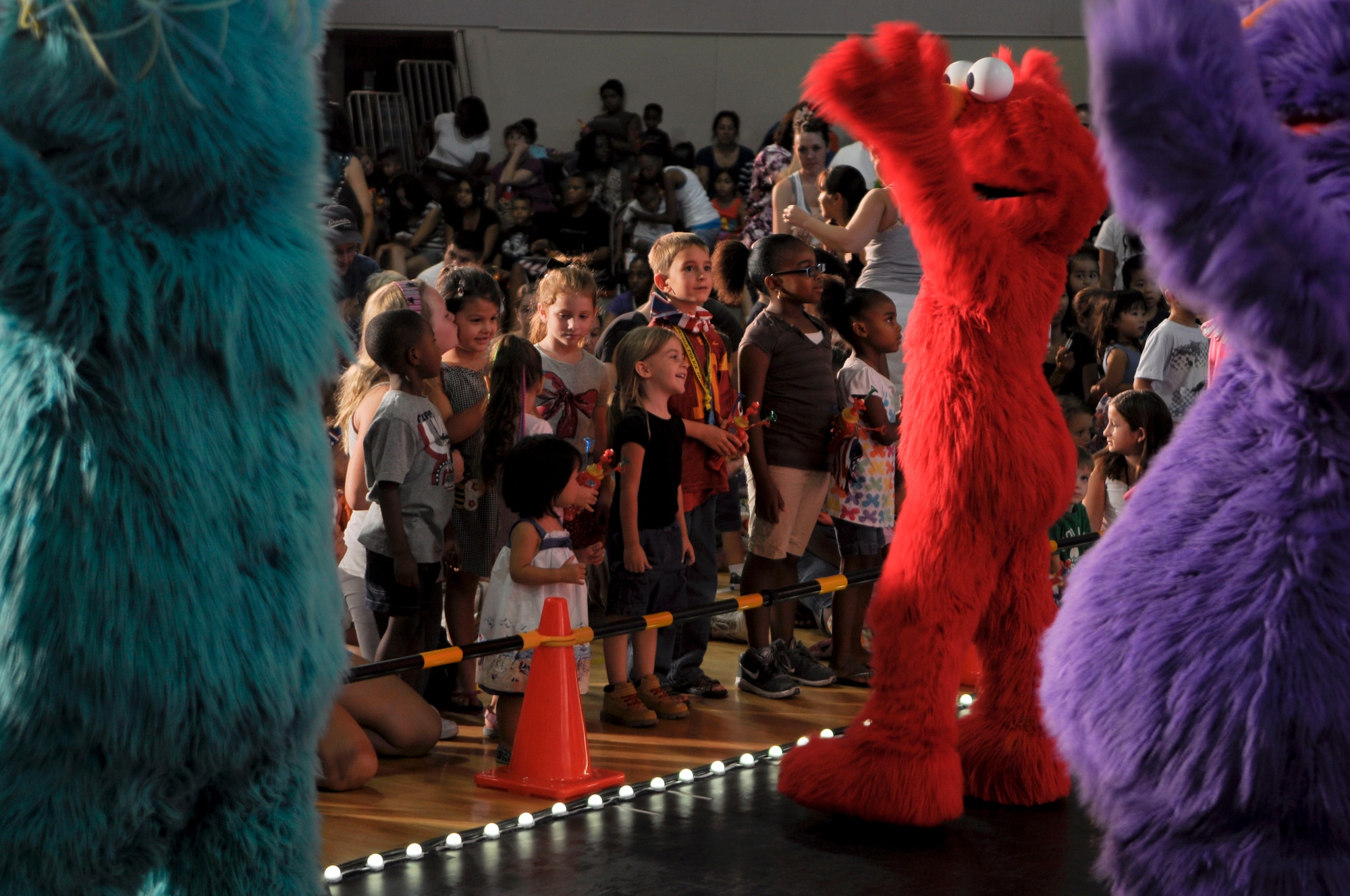 Excited children stand near the stage during The Sesame Street/USO Experience for Military Families. The show helped children understand that moving due to a parent’s permanent-change-of-station may be sad and difficult but keeping in touch with friends is easy. The show came to Luke Air Force Base Aug. 31 and Sept. 1. They will travel the United States before heading to bases overseas.  (U.S. Air Force photo by Senior Airman C.J. Hatch)
