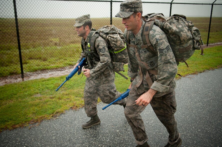 U.S. Air Force Airmen from the 820th Base Defense Group sprint to keep up their pace for the Pre-Ranger Focus Training Course at Moody Air Force Base, Ga., Sep. 5, 2012. Each person had three hours to complete a 12-mile course while carrying a simulated M-4 and 60 pound rucksack. (U.S. Air Force photo by Airman 1st Class Paul Francis/Released)
