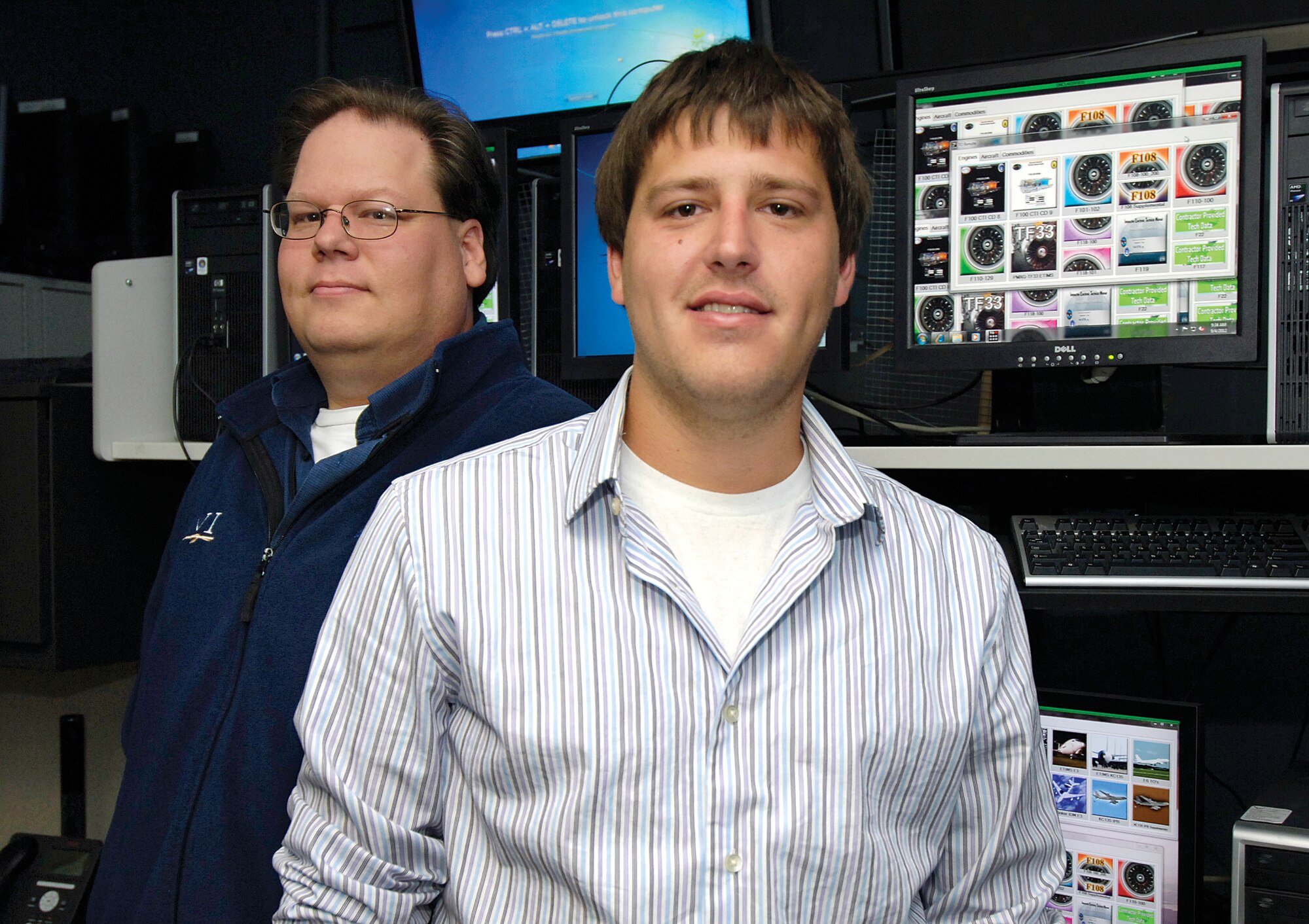 Blake Davis, front, and Jeff Foltz made the ease of getting technical orders on line even easier when they created a new application for mechanics. The 72nd Communications Directorate developers made an easy-to-navigate site where finding a specific engine or aircraft technical order is a click away. (Air Force photo by Margo Wright)
