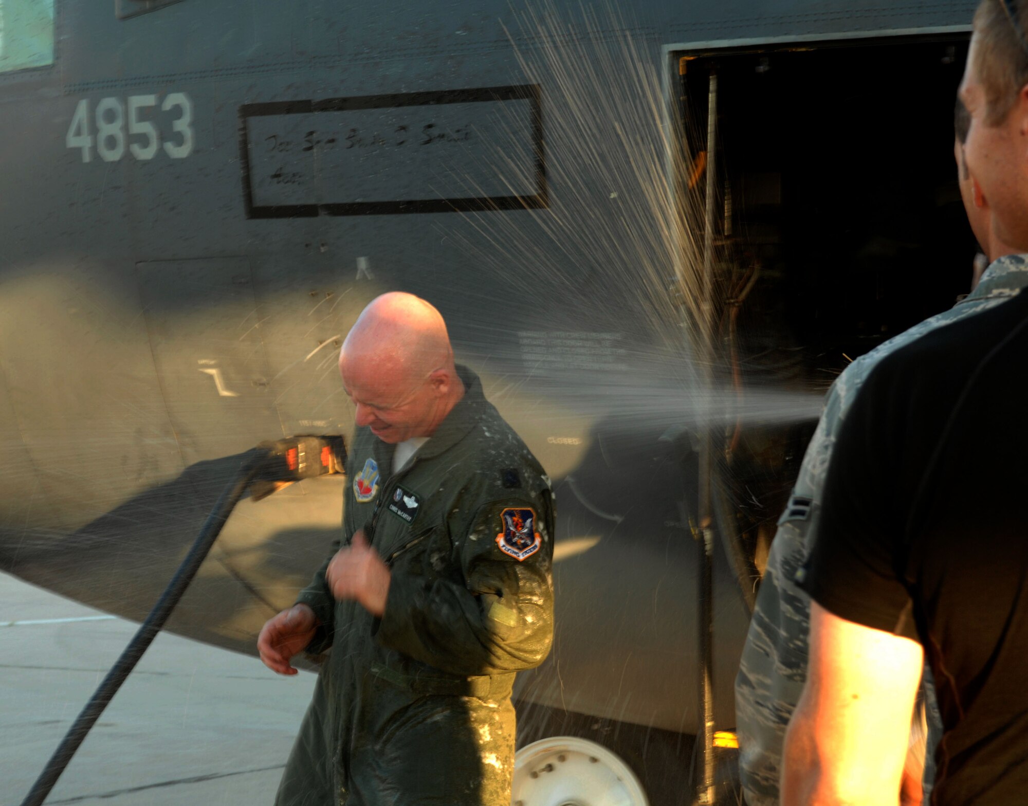 U.S. Air Force Lt. Col. Christopher McCarthy, 563rd Rescue Group instructor pilot, gets sprayed with champagne after disembarking the HC-130P after its final flight on Davis-Monthan Air Force Base, Ariz., Sept. 12, 2012. Colonel McCarthy has been flying HC-130Ps for the past 11 years. (U.S. Air Force photo by Airman 1st Class Saphfire Cook)