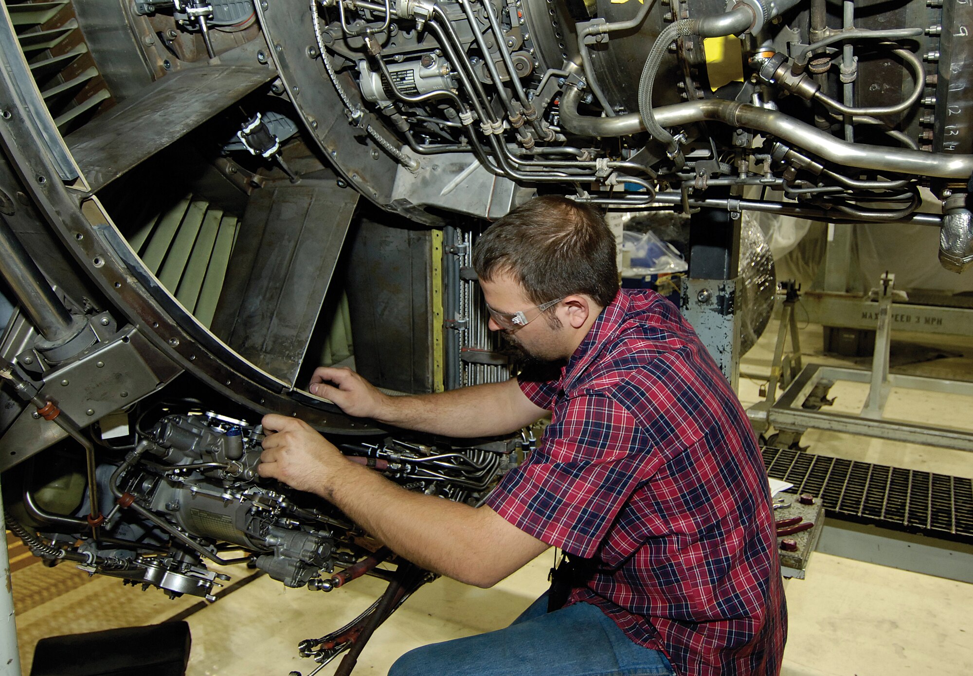 Tinker jet engine mechanic Craig Richards, of the 546th Propulsion Maintenance Squadron, works on an F108 engine in the F108 Assembly Shop, Bldg. 9001. The powerhouse of the Air Force KC-135 Stratotanker and Navy E-6B is getting attention as proposed upgrades promise to reduce the maintenance price tag, step up fuel efficiency and save money for the two services. (Air Force photo by Margo Wright)