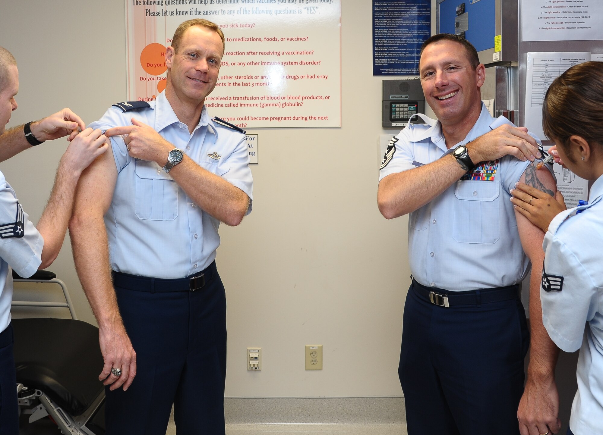 The 14th Flying Training Wing Commander, Col. Jim Sears, and Command Chief, Chief Master Sgt. Vance Kondon, get their influenza vaccinations Sept. 10 at the Medical Group.  The 14th Medical Group is now offering flu mists and shots on Monday, Wednesday and Friday from 8 a.m. to 10 a.m. and 3 p.m. to 5 p.m.  All Columbus Air Force Base active duty personnel are required to receive a flu immunization no later than Oct. 19.   (U.S. Air Force Photo/Airman 1st Class Charles Dickens)