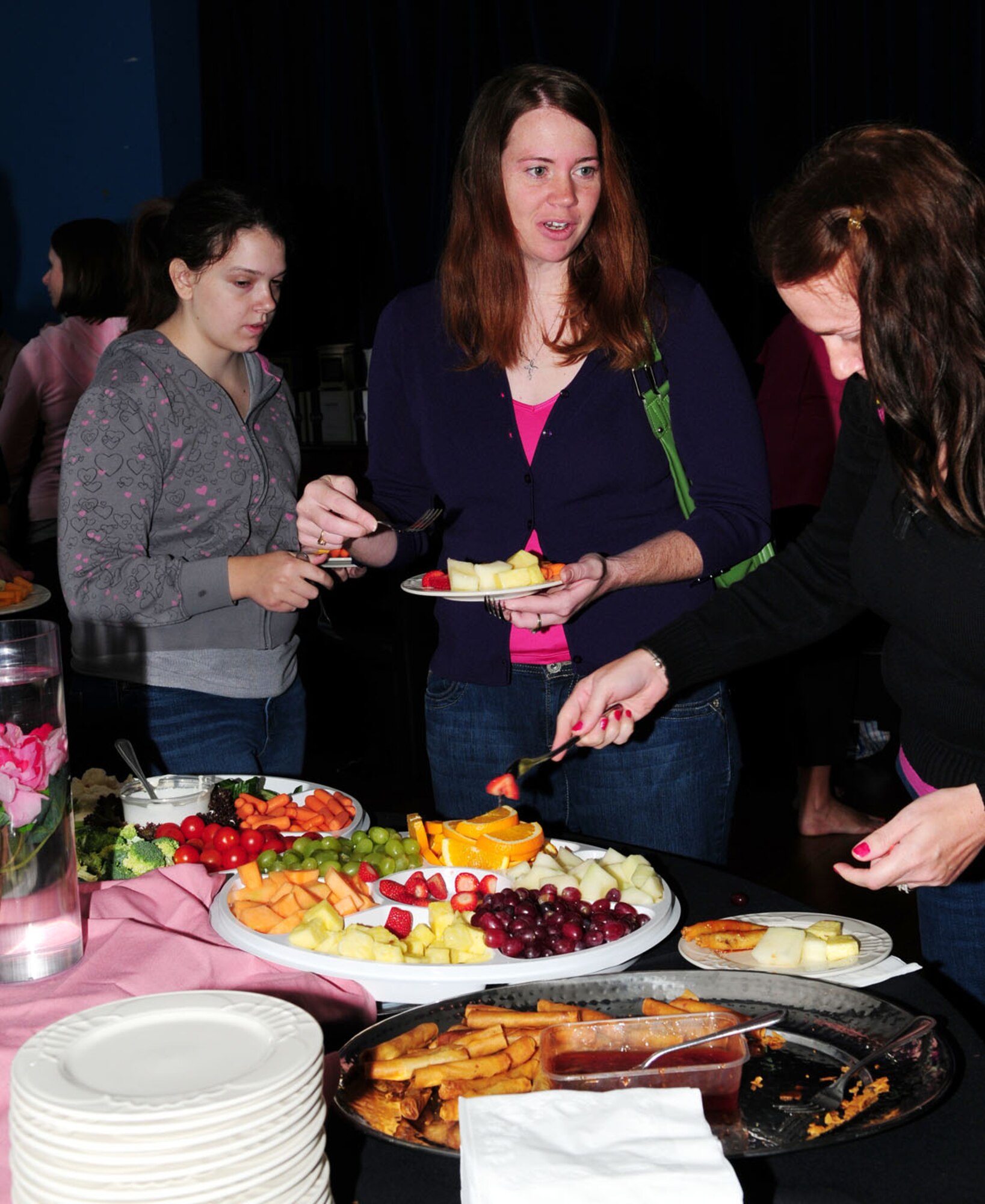 RAF MILDENHALL, England – Spouses socialize while sampling fruit and desserts at the Spouses’ Spa Day Sept. 14, 2012, at the Bob Hope Community Center, RAF Mildenhall. The 100th Force Support Squadron hosted the event so spouses could enjoy pampering treatments. (U.S. Air Force photo/Karen Abeyasekere)