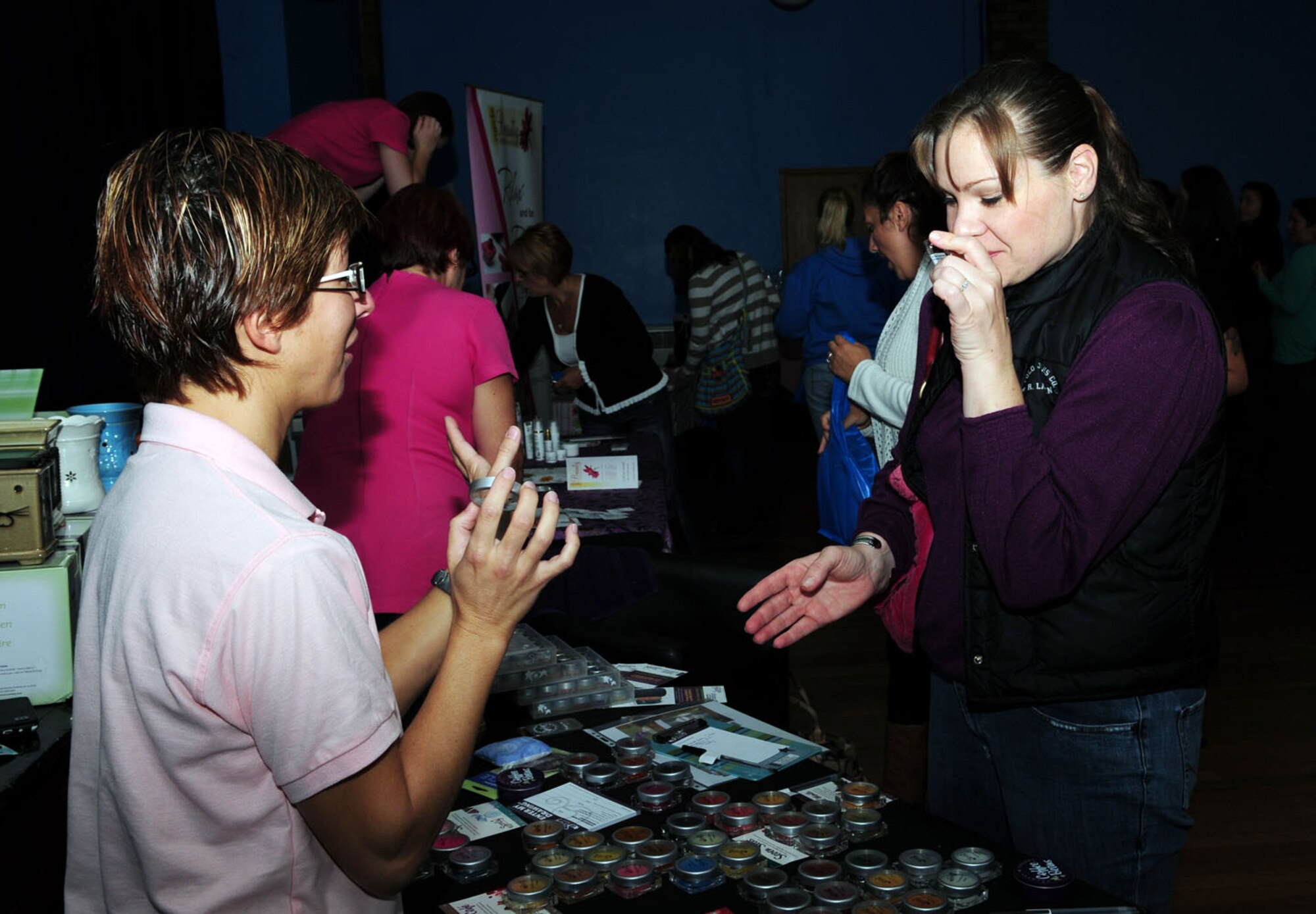 RAF MILDENHALL, England – Right, Tara Taylor, an RAF Feltwell spouse, smells different scented liquid candles from Rossella Flick, product demonstrator, at the Spouses’ Spa Day Sept. 14, 2012, at the Bob Hope Community Center, RAF Mildenhall. Spouses had the opportunity to try out product demonstrations, manicures, eyebrow waxing and massages, as well as sample cup cakes, wine and other desserts. (U.S. Air Force photo/Karen Abeyasekere)