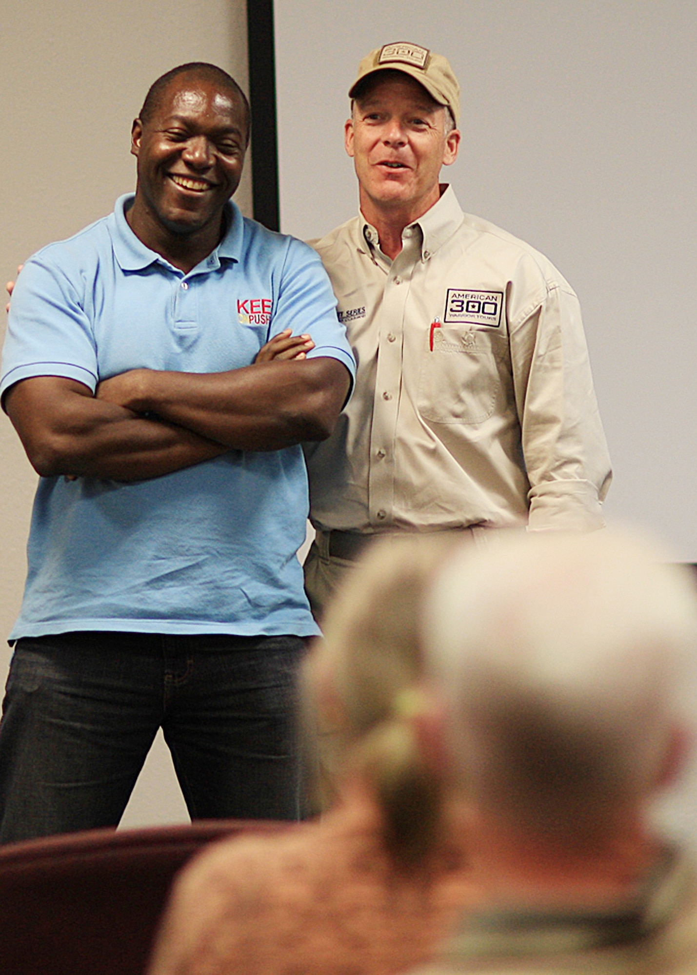 Robbi Powers, founder, American300 and Devon Harris, 1988 Jamaican Olympic bobsledding team member, speak to 90th Medical Group personnel Sept. 6 at the F. E. Warren Base Clinic. Devon Harris toured F. E. Warren as part of the ongoing “Never Quit” American300 campaign. 