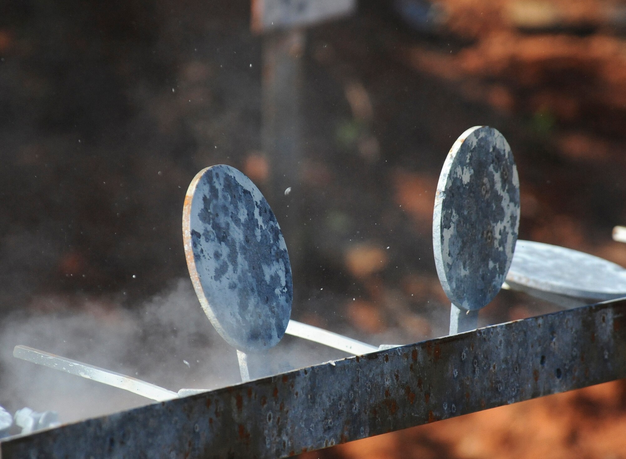 A bullet disintegrates after hitting its target at the Bossier Parish Sheriff?s Office pistol range in Plain Dealing, La., Sept. 11. Airmen from the 2nd Security Forces Squadron practiced firing the M-9 pistol in preparation for the 2012 annual Global Strike Challenge. Seven Airmen were selected to represent the 2 SFS team. During the challenge, security forces Airmen will compete in three main categories; tactics, weapons and a mental and physical challenge. The competition is set to begin Sept. 24, and will be held at Camp Guernsey, Wyo. (U.S. Air Force photo/Senior Airman Micaiah Anthony)(RELEASED)