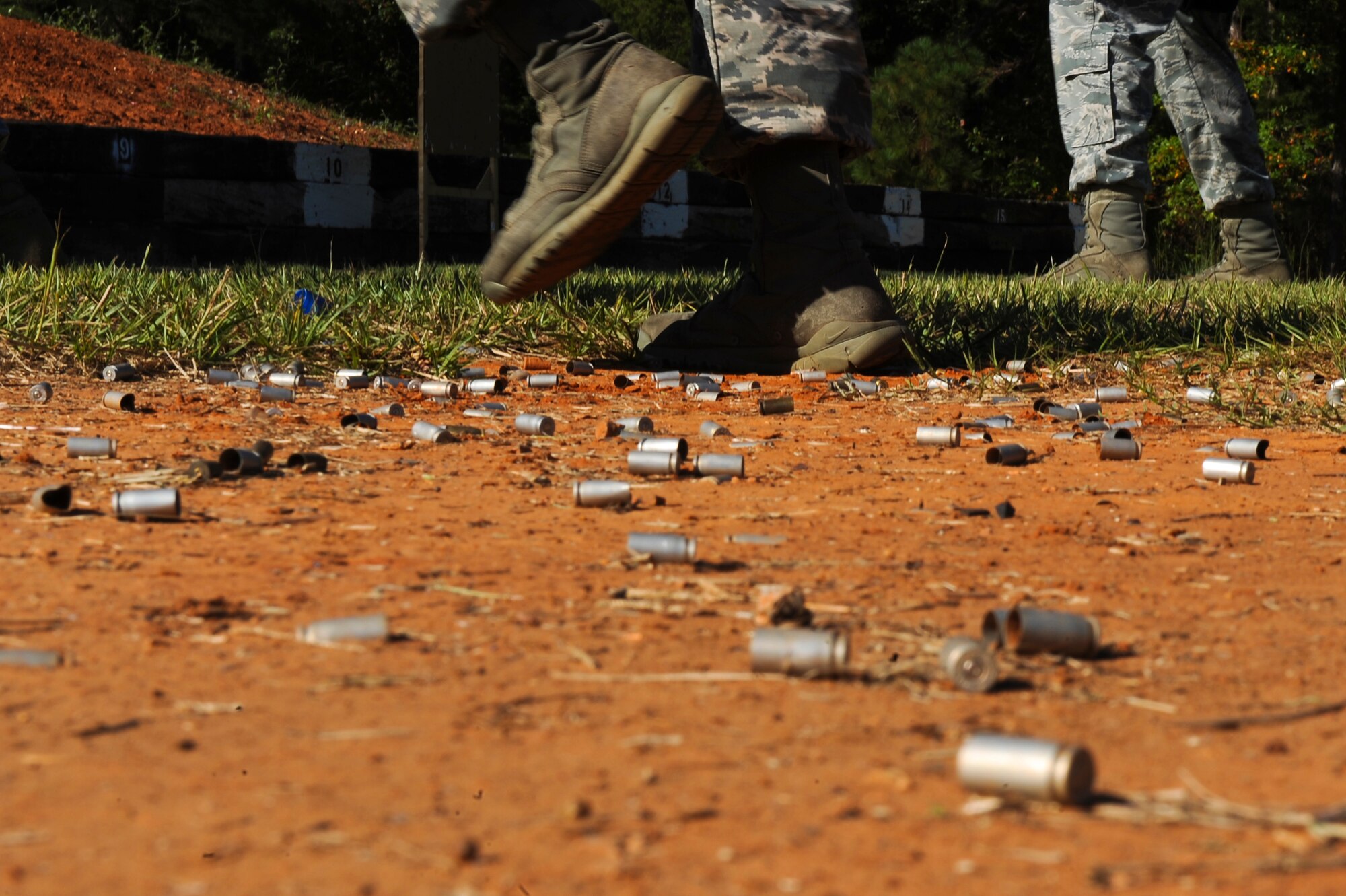 An Airman from the 2nd Security Forces Squadron jogs in place during a head-to-head shoot off at the Bossier Parish Sheriff?s Office pistol range in Plain Dealing, La., Sept. 11. The Airmen donned their gas masks and competed against each other to see who could shoot their target the fastest. The loser had to do 10 push-ups, and if the shooter missed the target they had to complete an additional 10 push-ups. After the Airmen shot or exercised, they returned to the shooting line and jogged in place to keep their heart rate up. The Airmen did this drill to help them prepare for the 2012 annual Global Strike Challenge. (U.S. Air Force photo/Senior Airman Micaiah Anthony)(RELEASED)