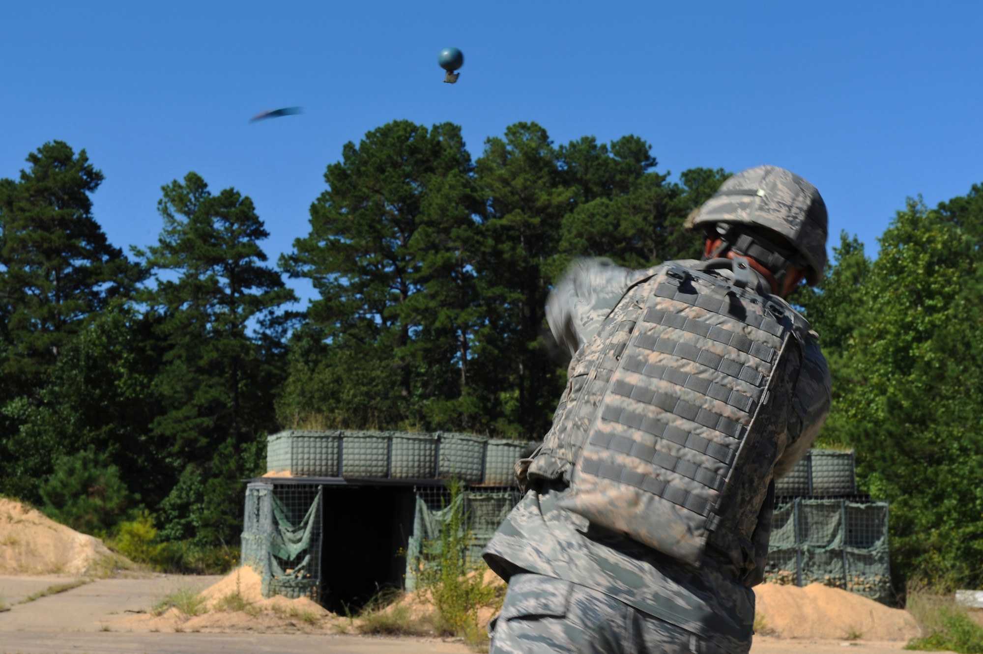 1st Lt. Kendall Benton, 2nd Security Forces Squadron, throws a training grenade on Barksdale Air Force Base, La., Sept. 10. Airmen from the 2 SFS practiced throwing training grenades into a bunker in preparation for the 2012 annual Global Strike Challenge. During the challenge, security forces Airmen will compete in three main categories; tactics, weapons and a mental and physical challenge. The competition is set to begin Sept. 24, and will be held at Camp Guernsey, Wyo. (U.S. Air Force photo/Senior Airman Micaiah Anthony)(RELEASED)