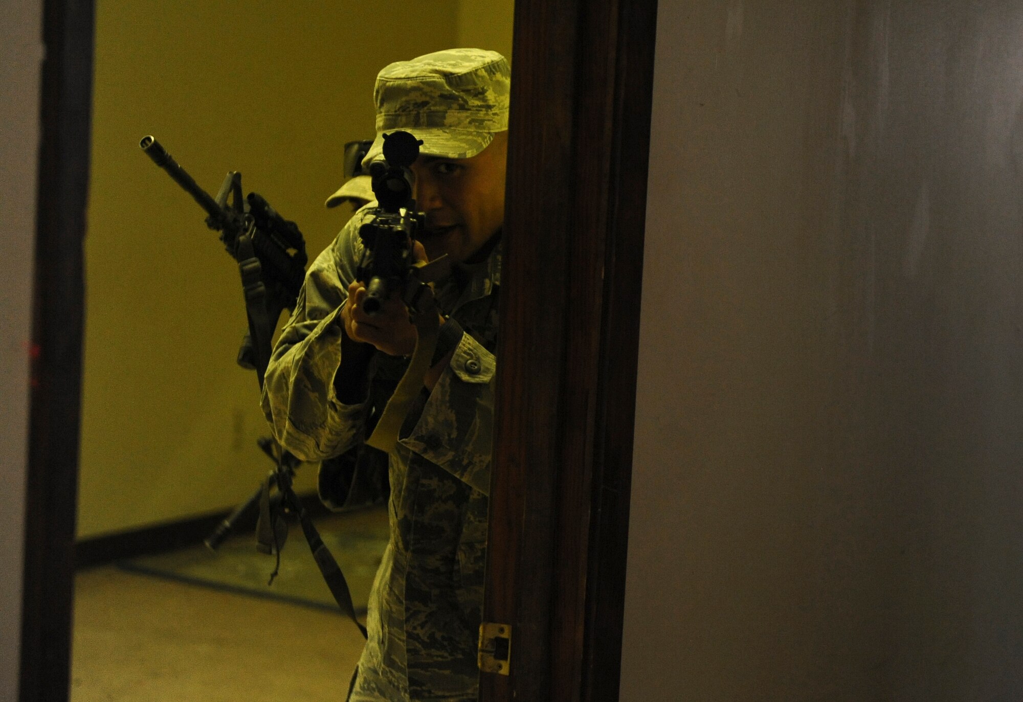 Senior Airman Jezrell Zimmerman, 2nd Security Forces Squadron, gives directions to a team member while clearing a building on Barksdale Air Force Base, La., Sept. 10. The Airmen spent the afternoon practicing tactical room clearing for the 2012 annual Global Strike Challenge. During the challenge, security forces Airmen will compete in three main categories; tactics, weapons and a mental and physical challenge. The competition is set to begin Sept. 24, and will be held at Camp Guernsey, Wyo. (U.S. Air Force photo/Senior Airman Micaiah Anthony)(RELEASED)