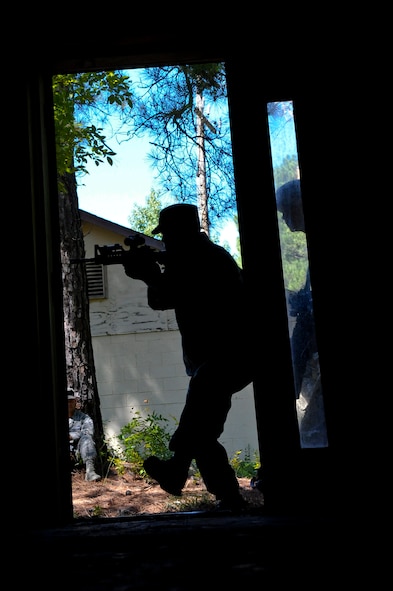 A 2nd Security Forces Squadron Airman leads his team into a building on Barksdale Air Force Base, La., Sept. 10. The Airmen spent the afternoon practicing tactical room clearing for the 2012 annual Global Strike Challenge. Each wing in the Air Force Global Strike Command sends a team to represent security forces, maintenance, munitions and operations to compete in the challenge. The competition for security forces begins Sept. 24, and will be held at Camp Guernsey, Wyo. (U.S. Air Force photo/Senior Airman Micaiah Anthony)(RELEASED)
