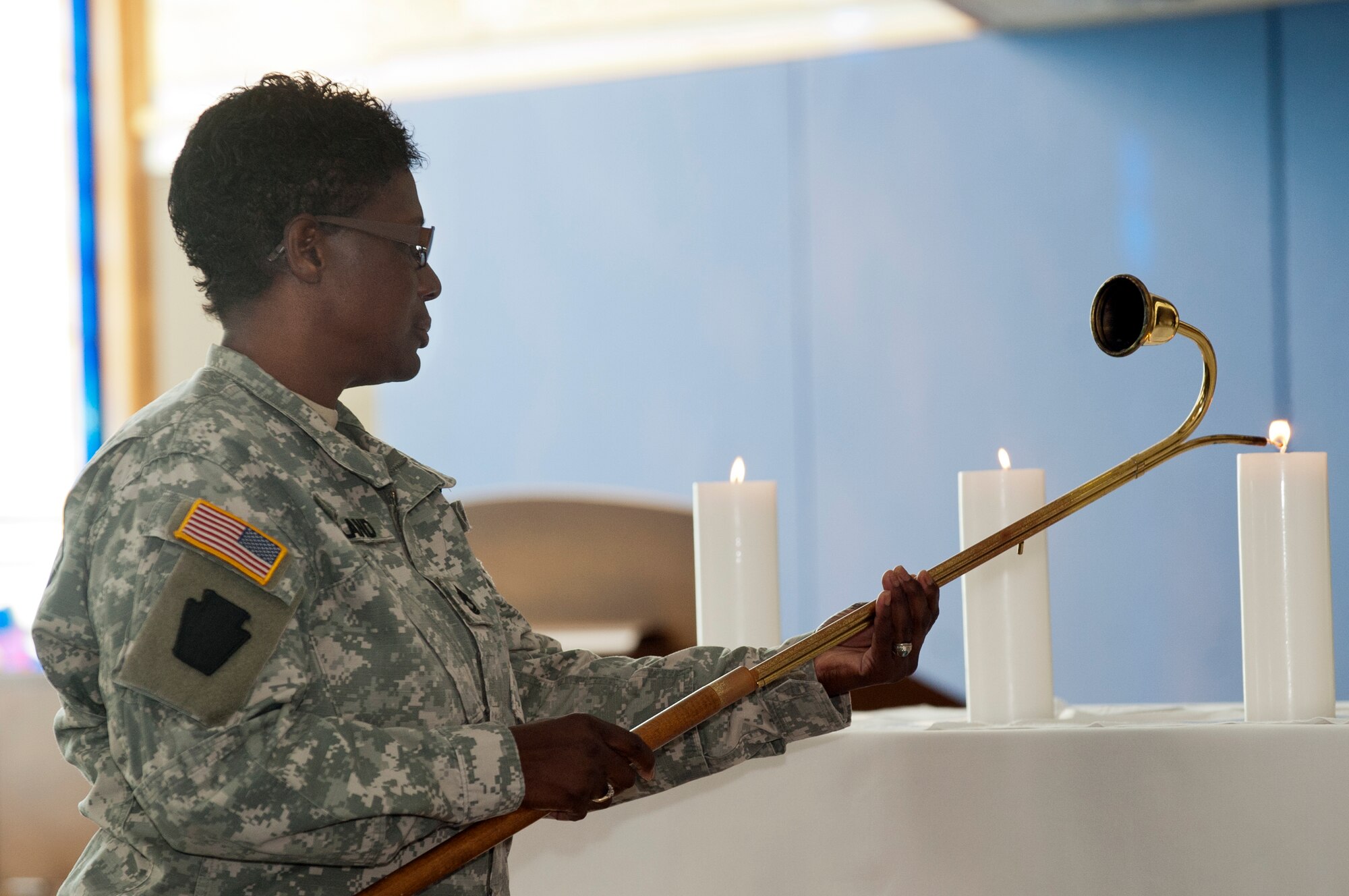 Sgt. 1st Class Bernadette Kirkland, Army Support Activity Dix chaplain assistant, lights a candle at 9:37 a.m., the moment of impact of the Pentagon, during the Joint Base McGuire-Dix-Lakehurst 9/11 Remembrance Ceremony held Sept. 11 at the McGuire Chapel. (U.S. Air Force photo by Wayne Russell/Released)