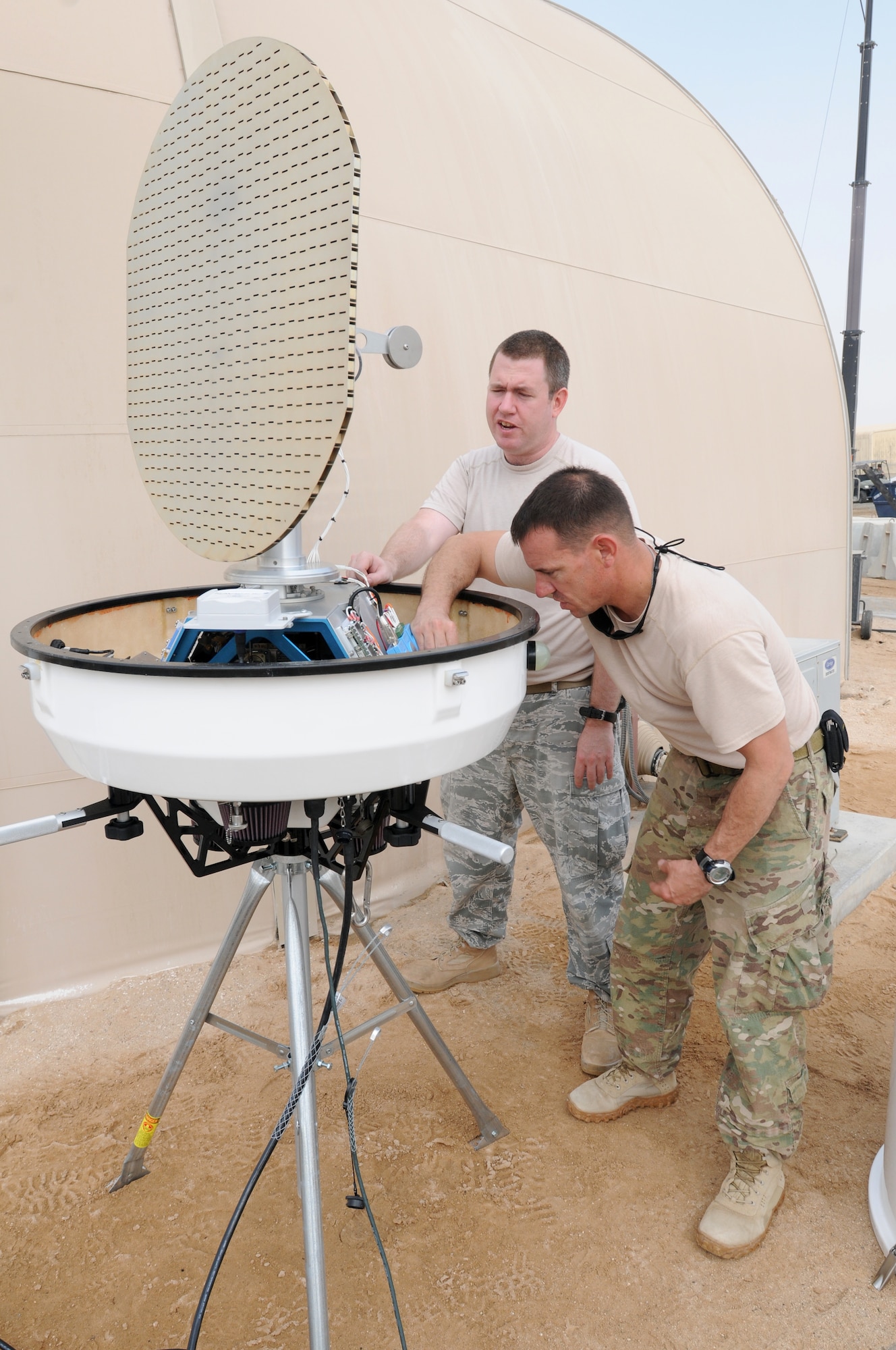 SOUTHWEST ASIA - U.S. Air Force Staff Sgt. Samuel Trammel and Tech. Sgt. Matthew Brown, U.S. Air Forces Central Weather Systems Support Cadre members, inspect a portable Doppler radar prior to installing it at the 380th Air Expeditionary Wing Sept. 12, 2012. Doppler radar will allow the 380th Expeditionary Operations Support Squadron Weather flight to interrogate a storm and gather real-time storm data. (U.S. Air Force photo/Tech. Sgt. Amanda Savannah)
